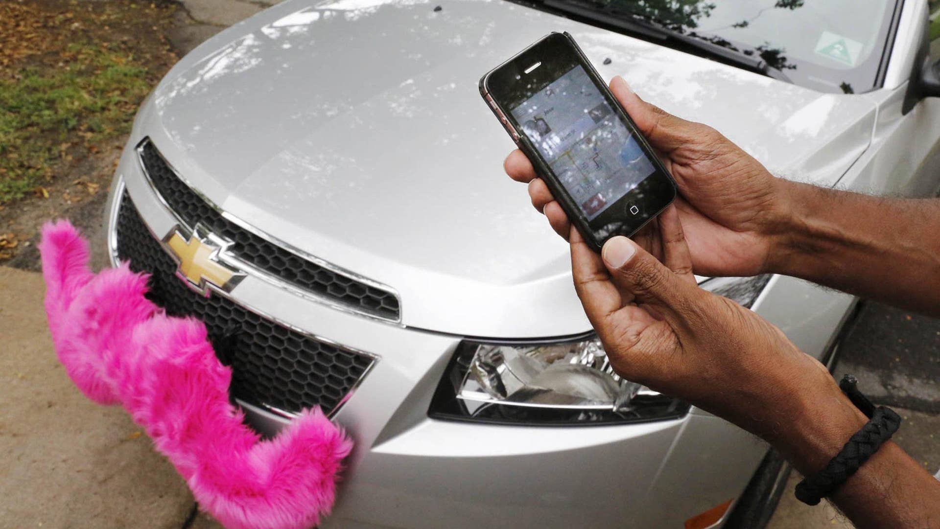 The Lyft app allows users to request a ride in Miami on June 4, 2014. Regulators across the U.S. and in Europe are struggling with how to control the digital-dispatch services that have upended the transportation business. © Jose A. Iglesias/Miami Herald/MCT/Alamy Live News