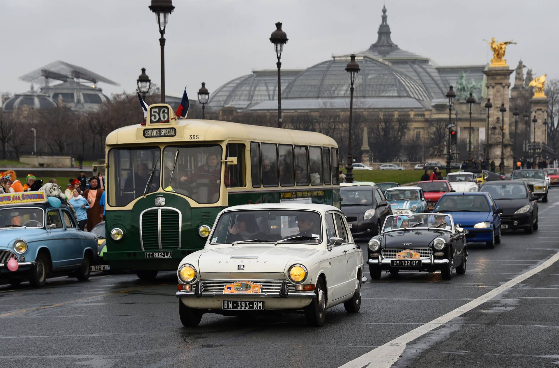 Vintage cars and a bus parade in the streets of Paris on January 8, 2017 during the 17th edition of the 'Traversee de Paris en Anciennes' (Vintage Paris Crossing), the largest gathering of classic vehicles. This 17th edition, organised by the association 'Vincennes en Anciennes' is dedicated to the 70's. / AFP / BERTRAND GUAY (Photo credit should read BERTRAND GUAY/AFP/Getty Images)