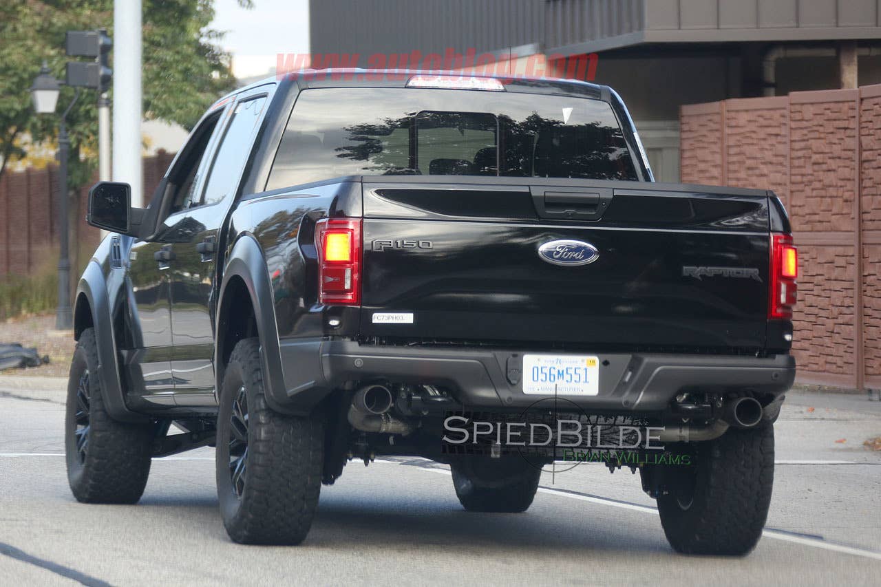 black 2017 ford f-150 raptor spy shot crew cab profile rear with exhaust