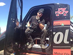 Racer Mike Ryan in his wrecked Freightliner hill climb special
