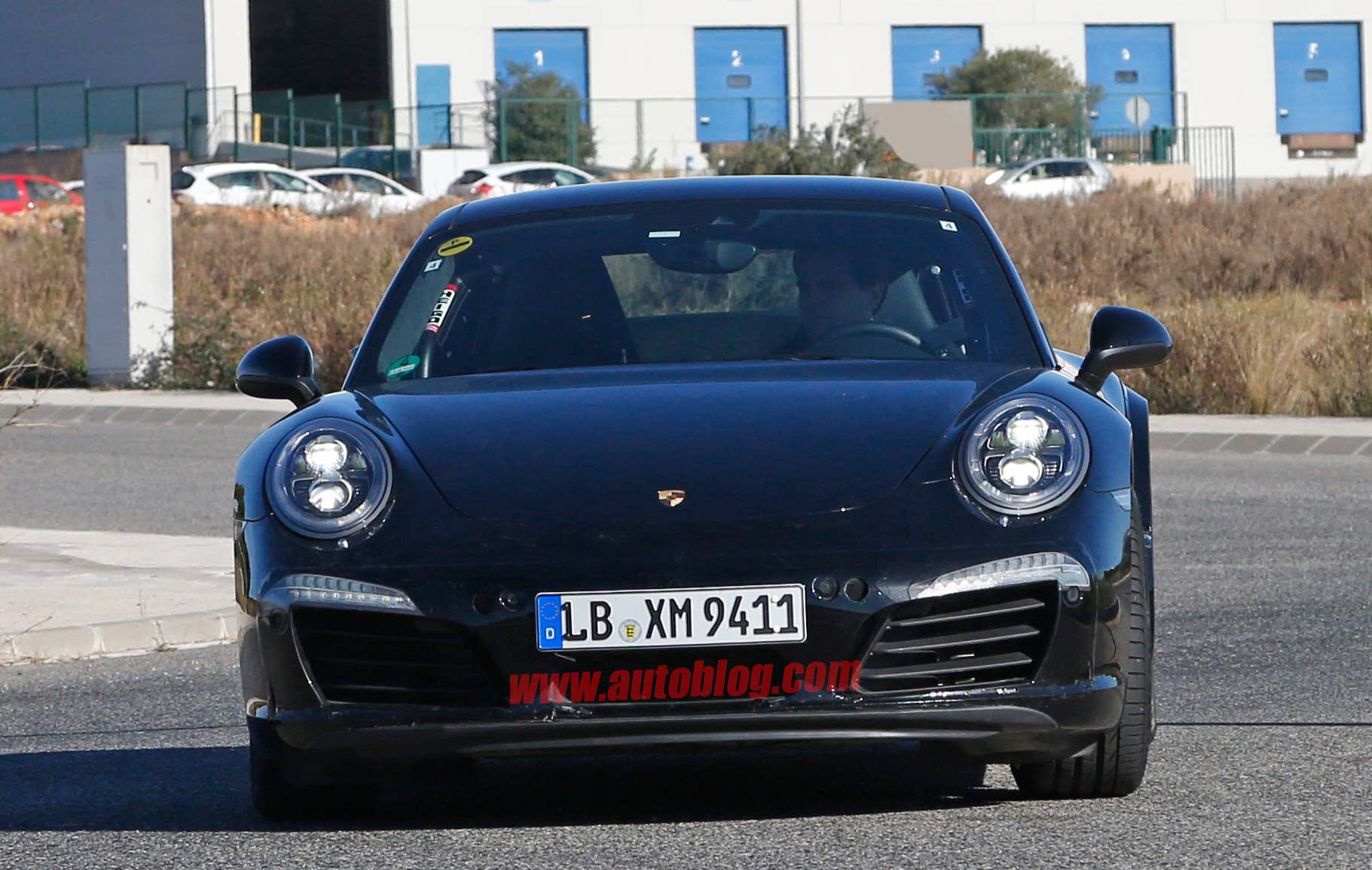 Spy shot of the next-generation 992-model Porsche 911 thought to hide a hybrid powertrain, front.