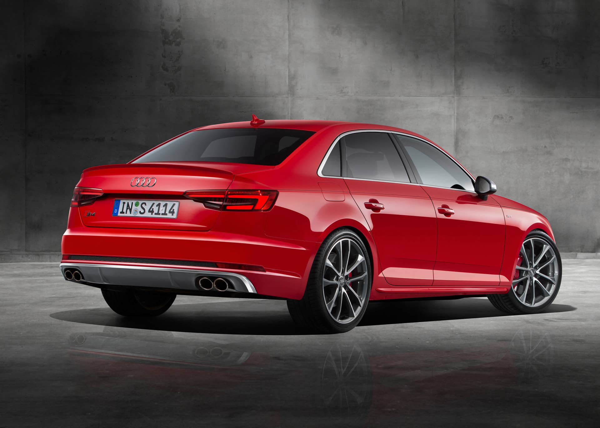 red 2017 audi s4 rear three quarters concrete