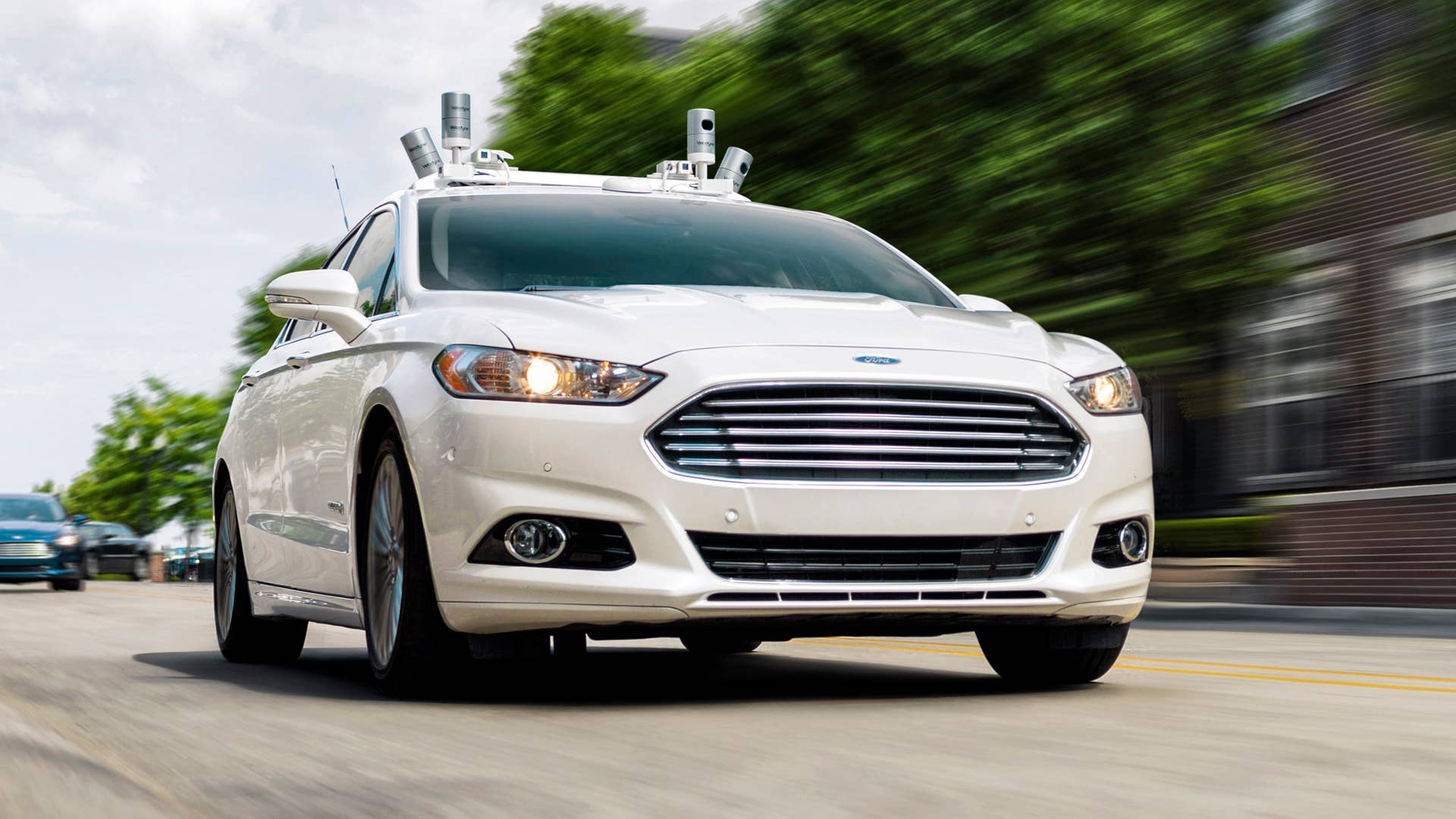 Ford fully autonomous Fusion Hybrid research vehicle on streets of Dearborn, MI. Ford has been researching autonomous vehicles for more than a decade and currently tests fully autonomous vehicles in Michigan, Arizona and California, and will triple its autonomous vehicle test fleet this year to have the largest of any automaker.