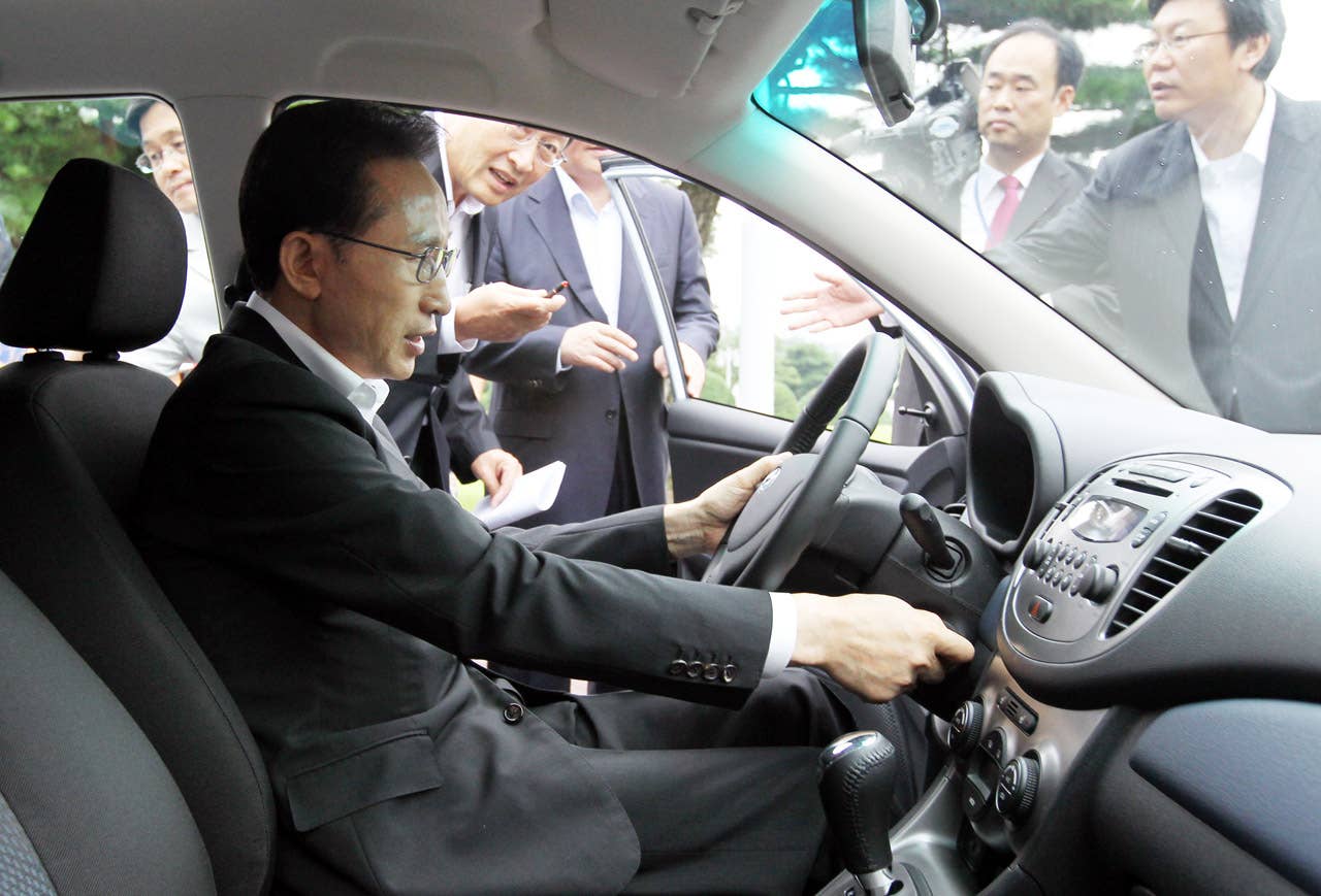 South Korean President Lee Myung-Bak dirves Hyundai's first full-speed electric vehicle, BlueOn, during an unveiling ceremony at the presidential Blue House in Seoul on September 9m 2010. Hyundai Motor unveiled South Korea's first full-speed electric car, designed to tap into the increasingly competitive electric auto market, hailed as the industry's future. (Photo credit: DONG-A ILBO/AFP/Getty Images)
