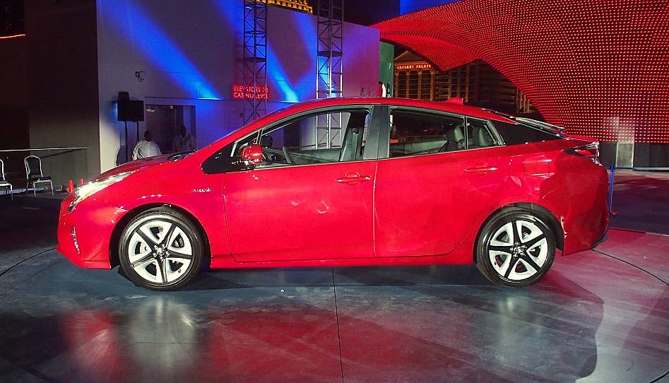 2016 Toyota Prius red, at reveal event, side profile