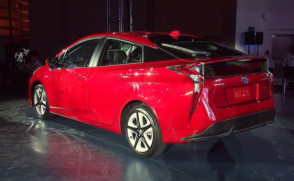 2016 Toyota Prius red, at reveal event, rear 3/4