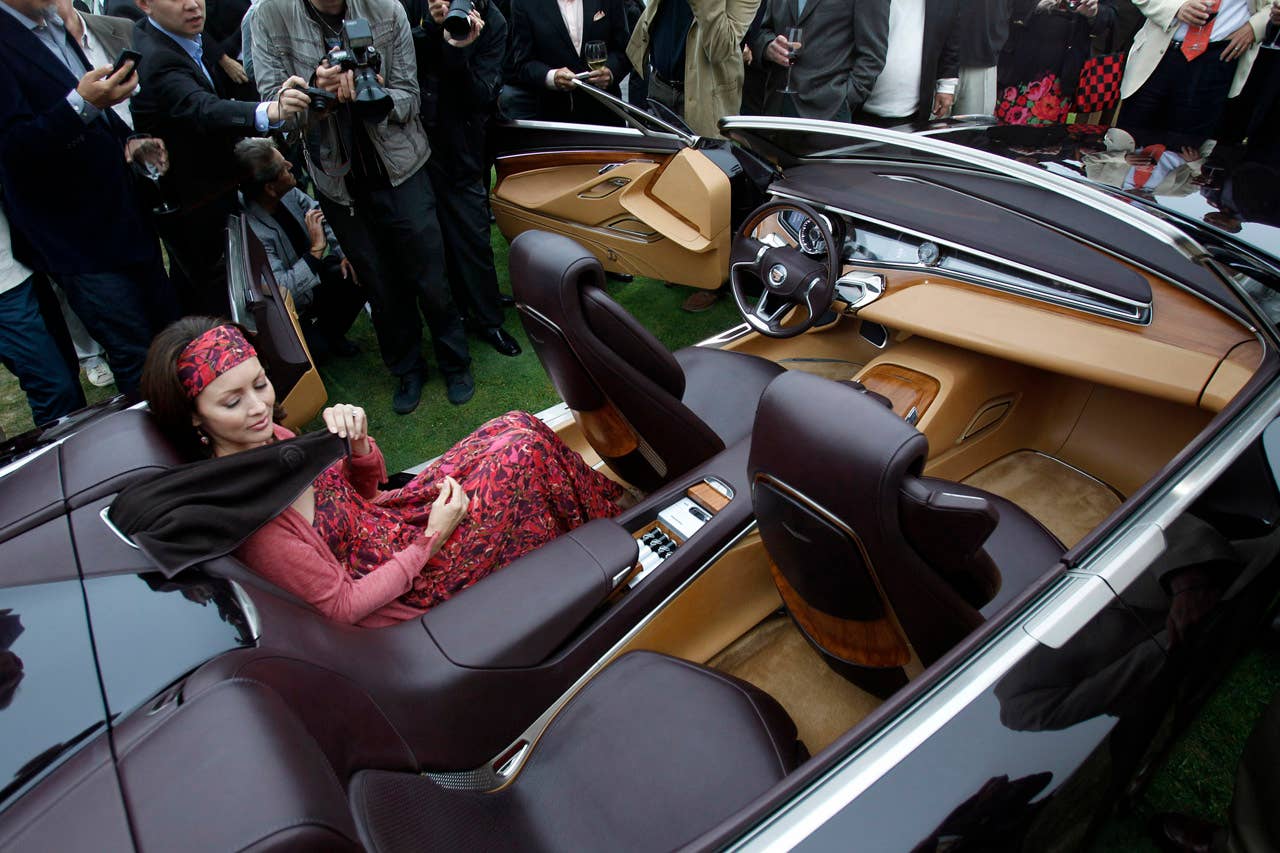 A model demonstrates the rear seat restraints in the Cadillac Ciel concept, an open-air grand-touring car, at its unveiling Thursday, August 18, 2011 in Carmel, California. The Ciel - pronounced "C-L," the French translation for sky - is a four-seat convertible powered by a twin-turbocharged version of the 3.6-liter Direct Injection V-6 engine, paired with a hybrid system using lithium-ion battery technology. (Cadillac News Photo) (08/18/2011)