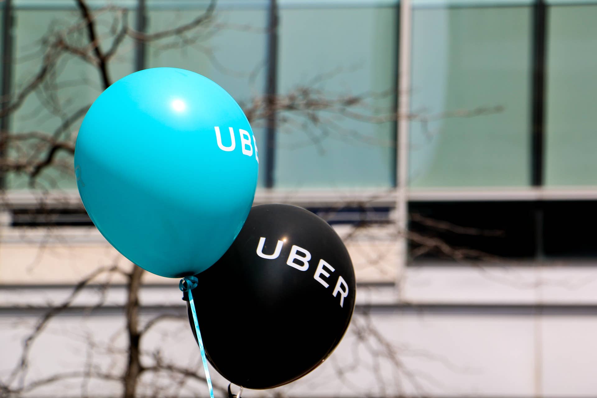 Montreal, Canada - April 29, 2016: A blue and a black balloon are floating outside at a pro Uber rally. The rally at Square Victoria, downtown Montreal, is held by drivers, clients and sympathizer of the ridesharing app.