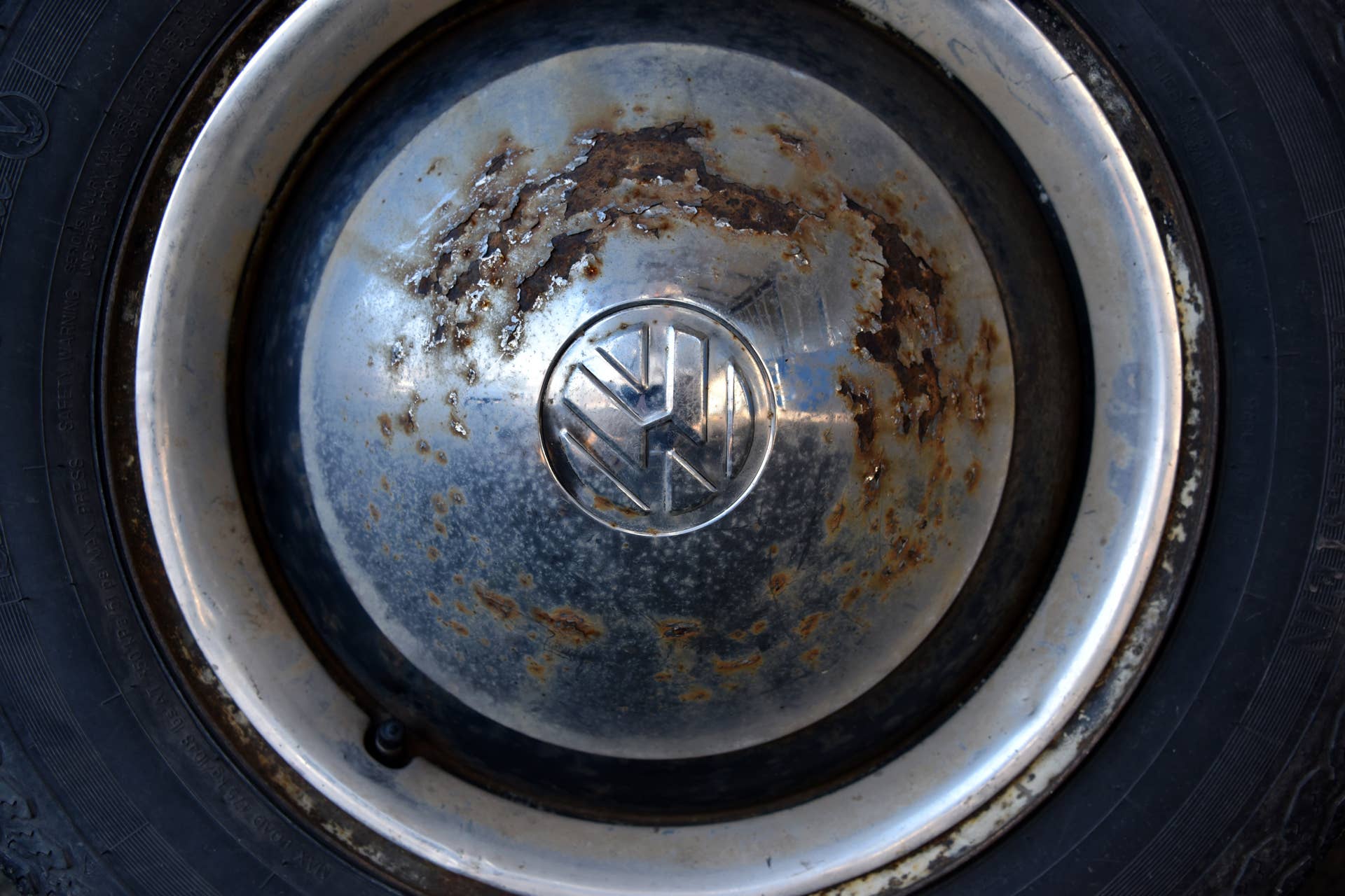 The logo of German car maker Volkswagen (VW) is seen on the wheel cap of a vintage VW beetle car at a workshop in Usseln, western Germany, on November 4, 2015. Shares in Volkswagen took a renewed battering as evidence emerged that the massive pollution cheating scandal engulfing the company may also involve petrol engines, not just diesel engines. AFP PHOTO / DPA / UWE ZUCCHI +++ GERMANY OUT +++ (Photo credit should read UWE ZUCCHI/AFP/Getty Images)