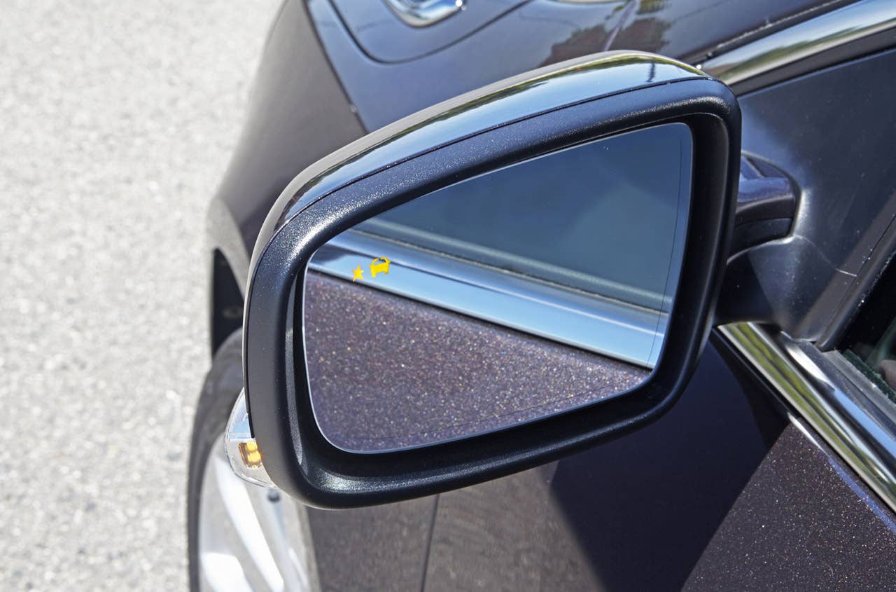 2014 Buick LaCrosse with Midnight Amethyst Metallic exterior color. Focus on side view mirror with safety alert icon.