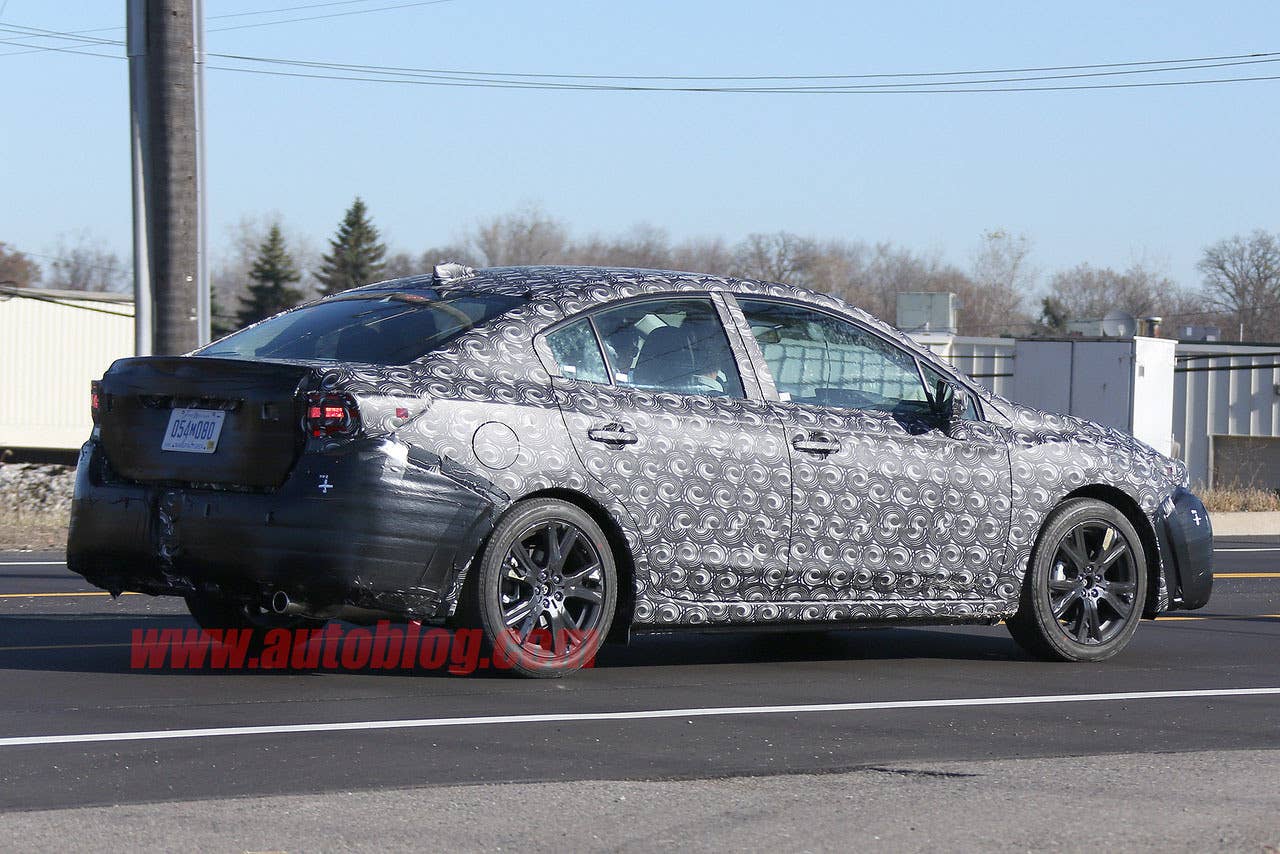 camouflaged 2017 subaru impreza spy shots rear three quarters