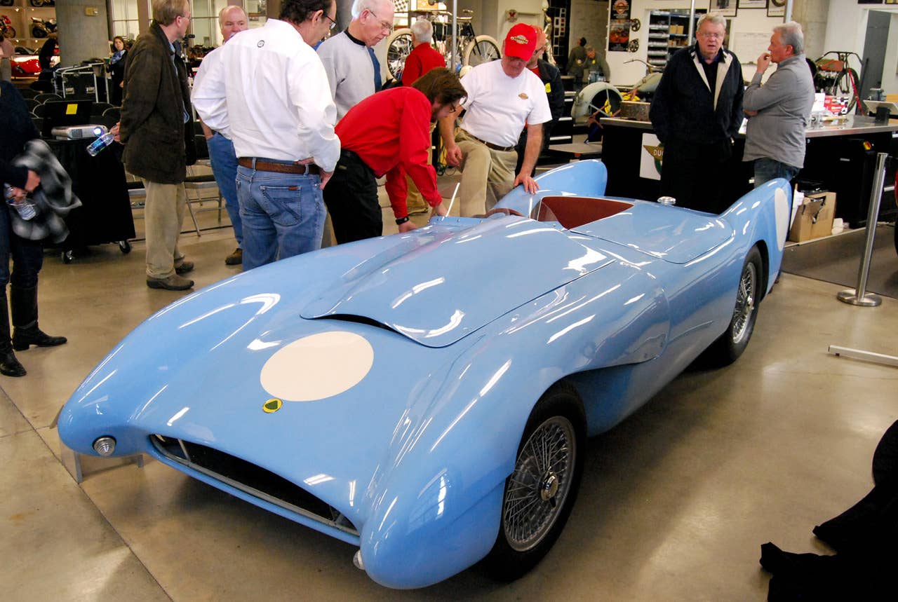 Barber Vintage Motorsports Museum lead auto restoration tech John Viviani, in the red shirt, helps Robert Kahmer climb back into his 1955 Lotus Mark X after 55 years.