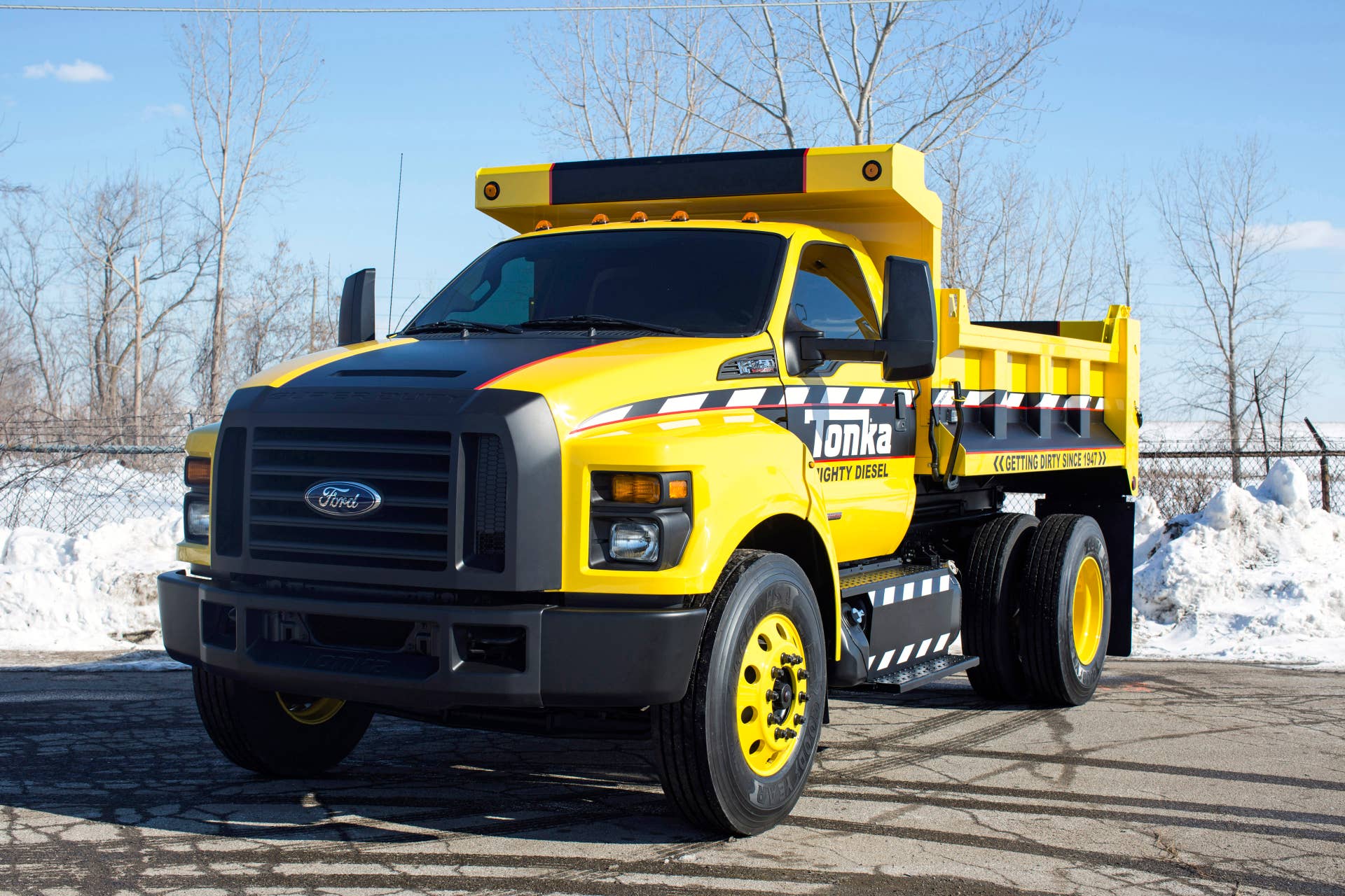Based on the all-new 2016 Ford F-650/F-750, the Mighty F-750 TONKA dump truck is is painted signature TONKA yellow with a custom blackout nostril grille and fully functional dump body from Truck Tech Engineers.