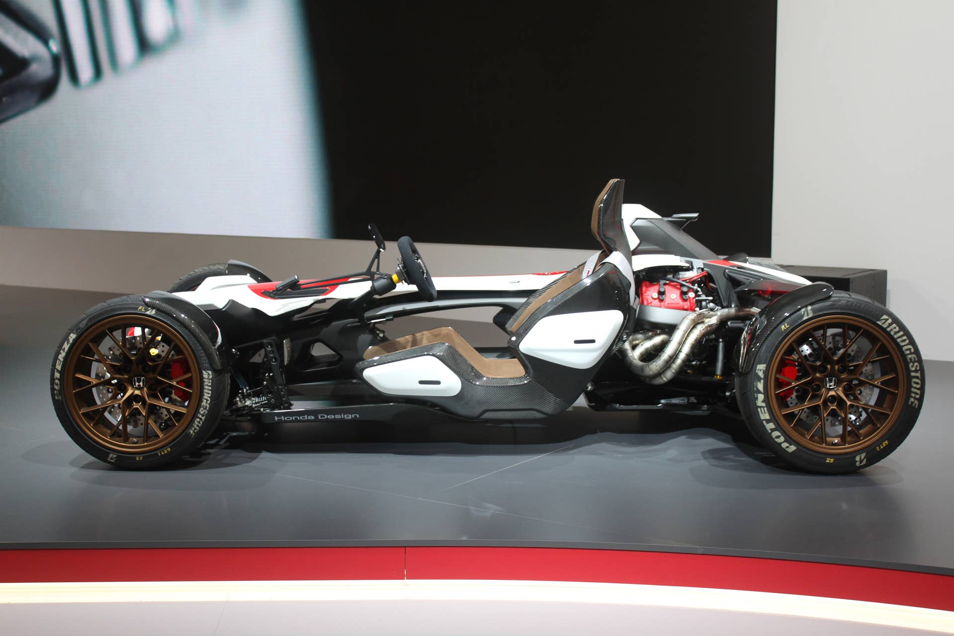 Honda Project 2  &  4 concept that combines the company's RC-213vs MotoGP bike with a car, at the 2015 Frankfurt Motor Show, side view.