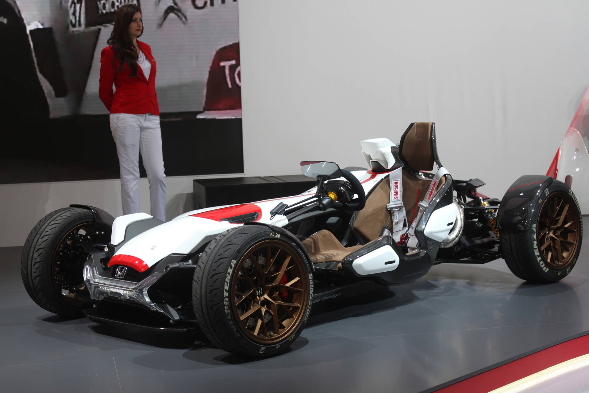 Honda Project 2  &  4 concept that combines the company's RC-213vs MotoGP bike with a car, at the 2015 Frankfurt Motor Show, low front three-quarter view.