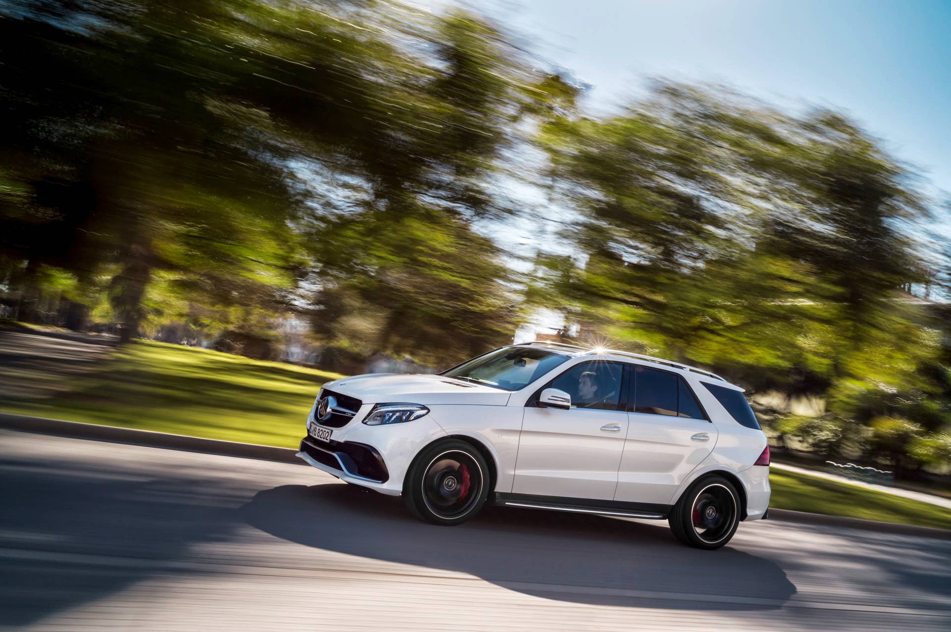 white mercedes gle63 s profile driving