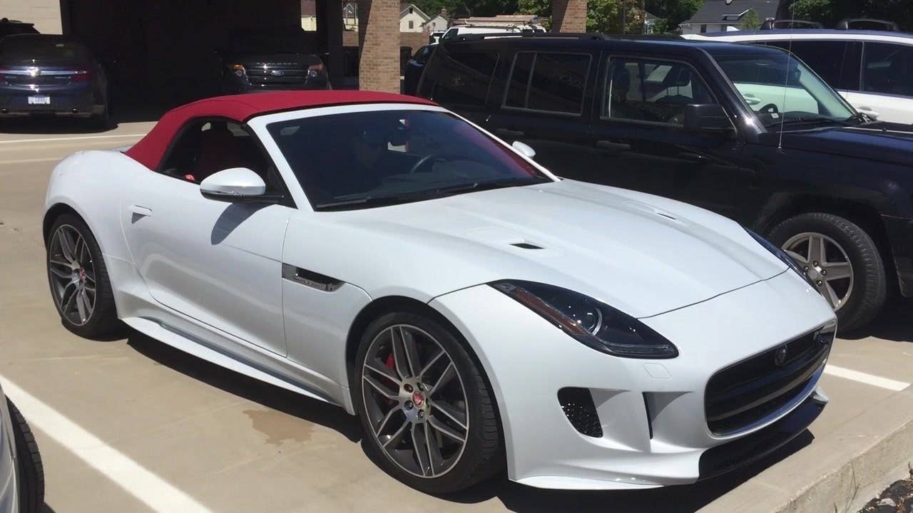 Autoblog Associate Producer Amr Sayour demonstrates how the 2016 Jaguar F-Type R AWD roof opens and closes.