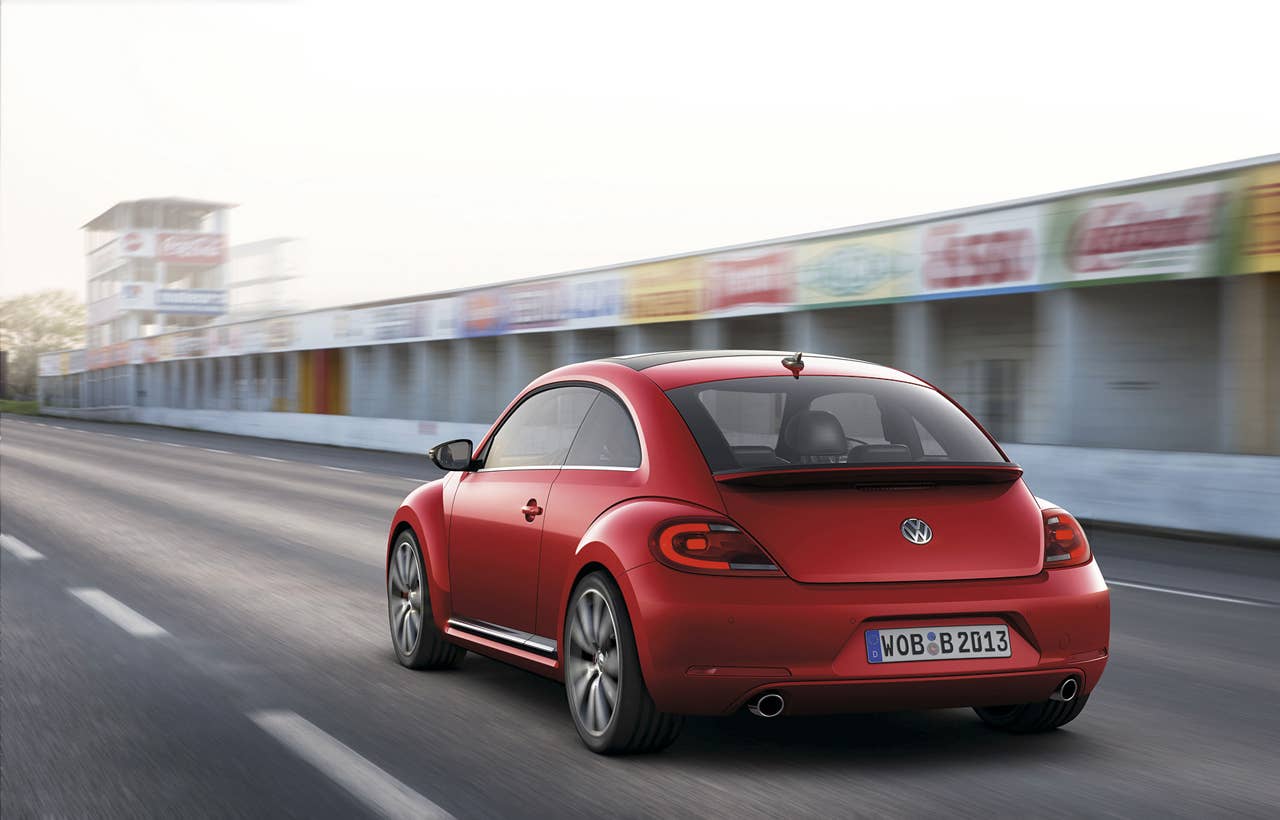 2012 Volkswagen Beetle in red, rear exterior in motion
