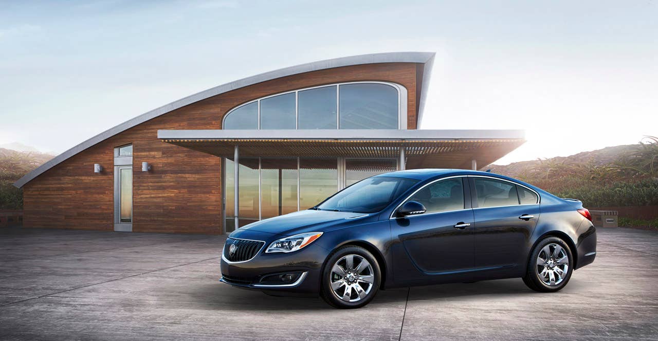 2014 Buick Regal Turbo side view with Graphite Blue Metallic exterior color and 18-inch chrome wheels