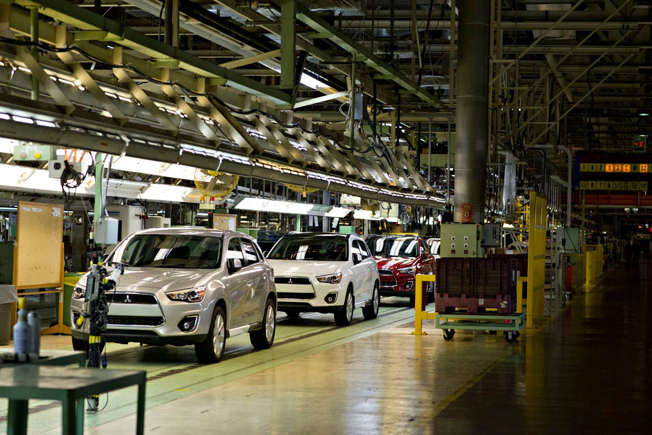 Pre-production 2013 Mitsubishi Outlander Sports travel on the assembly line at the Mitsubishi Motors North America manufacturing facility in Normal, Illinois, U.S., on Tuesday, July 17, 2012. Photographer: Daniel Acker