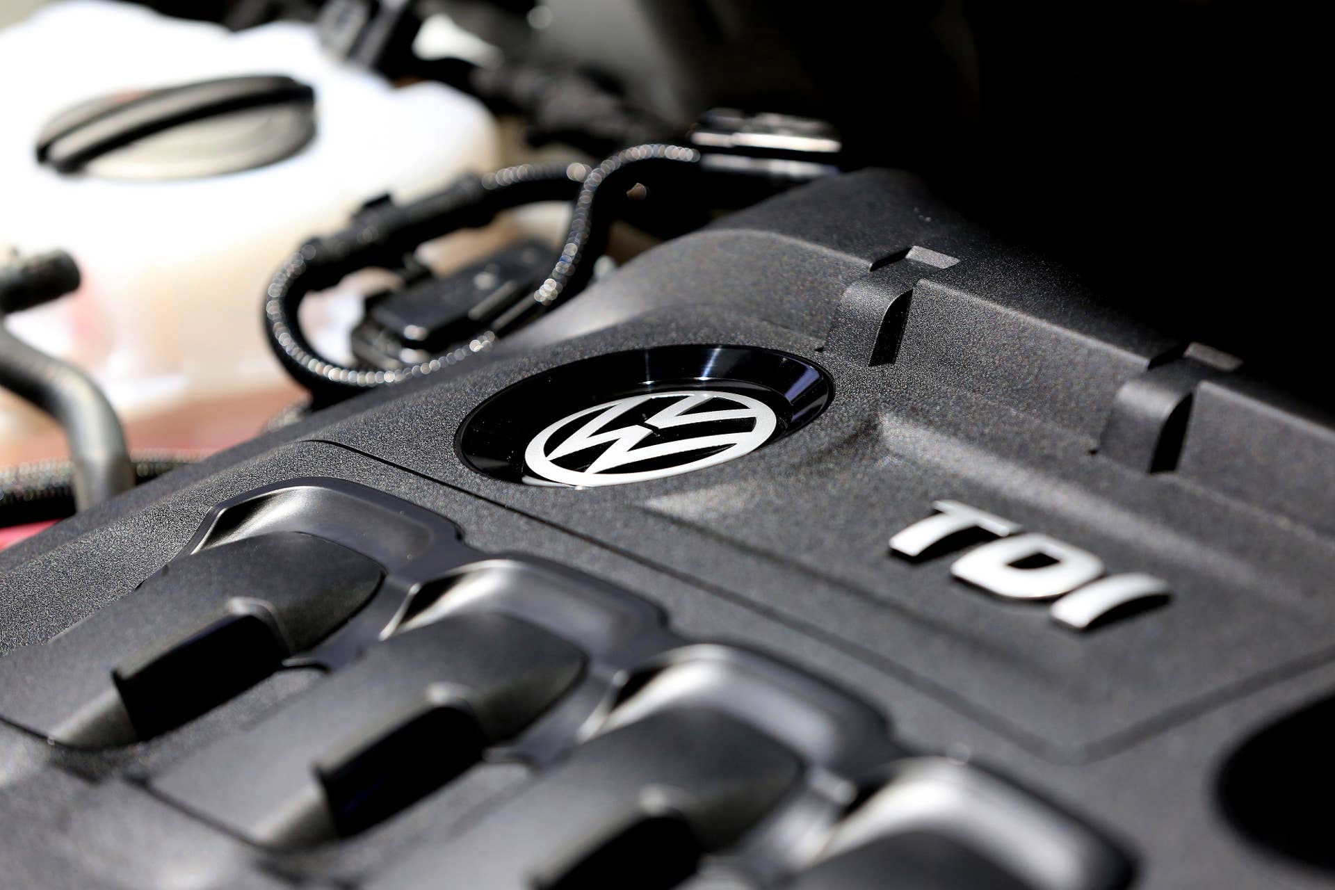 The turbo diesel injection (TDI) engine of a Volkswagen Tiguan R line automobile sits on display at the Volkswagen AG (VW) annual general meeting (AGM) in Hannover, Germany, on Wednesday, June 22, 2016. Matthias Mueller, chief executive officer of Volkswagen AG, sought to appease shareholder anger over the worst crisis in the carmakers history by shoring up internal controls to prevent a repeat of the diesel-emissions scandal. Photographer: Krisztian Bocsi/Bloomberg via Getty Images