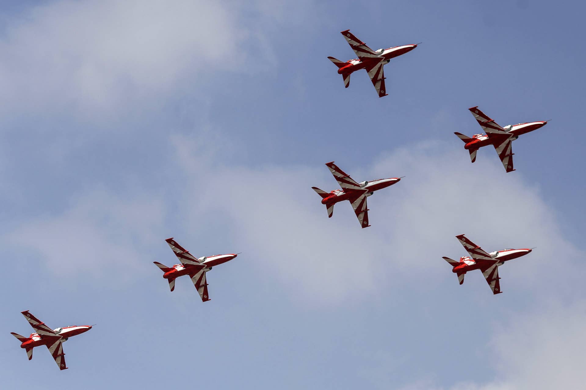 The 'Surya Kiran' (Sun Rays) Indian Air Force aerobatic display team perform in an aerial flying display at the Aero India air show at Air Force Station Yelahanka in Bengaluru, India, on Tuesday, Feb. 14, 2017. More than 750 global and Indian companies will attend the international show which runs through Feb. 18. Photographer: Dhiraj Singh/Bloomberg via Getty Images