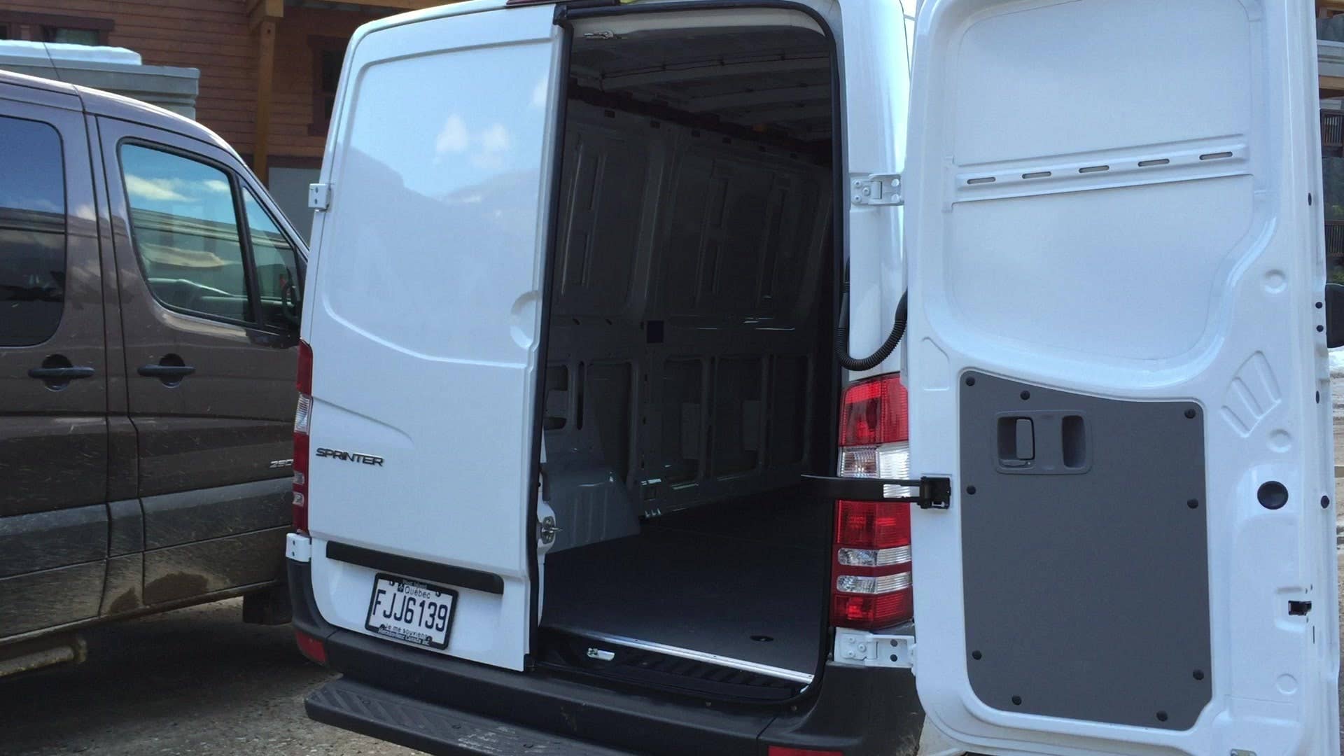 Senior Editor Steven Ewing shows the wide-opening rear doors of the 2015 Mercedes-Benz Sprinter 4x4.