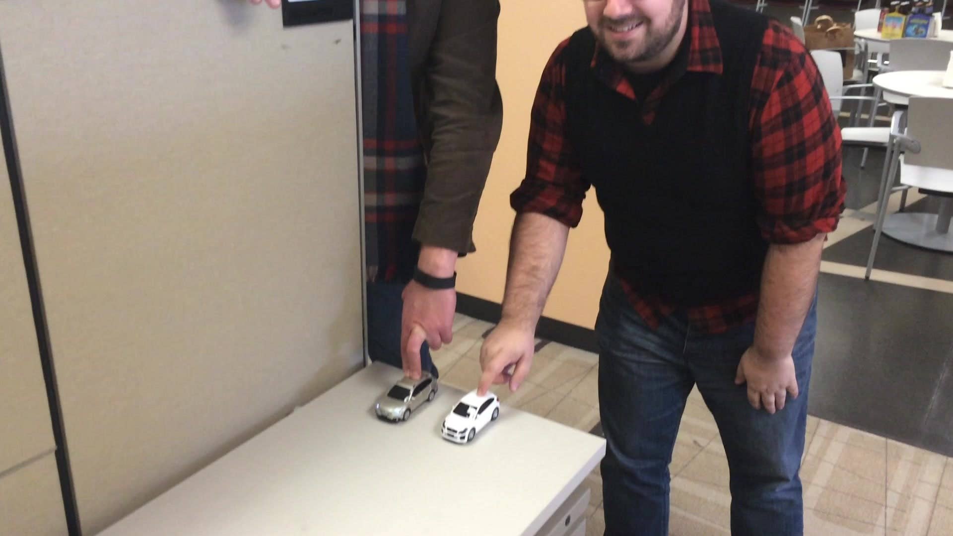 Autoblog Editors Steven Ewing and Seyth Miersma race their battery-powered Subaru model cars against each other. Both toy cars are equipped with a small sensor that stops the car before it can collide with the wall as a lighthearted demonstration of Subaru's EyeSight technology.