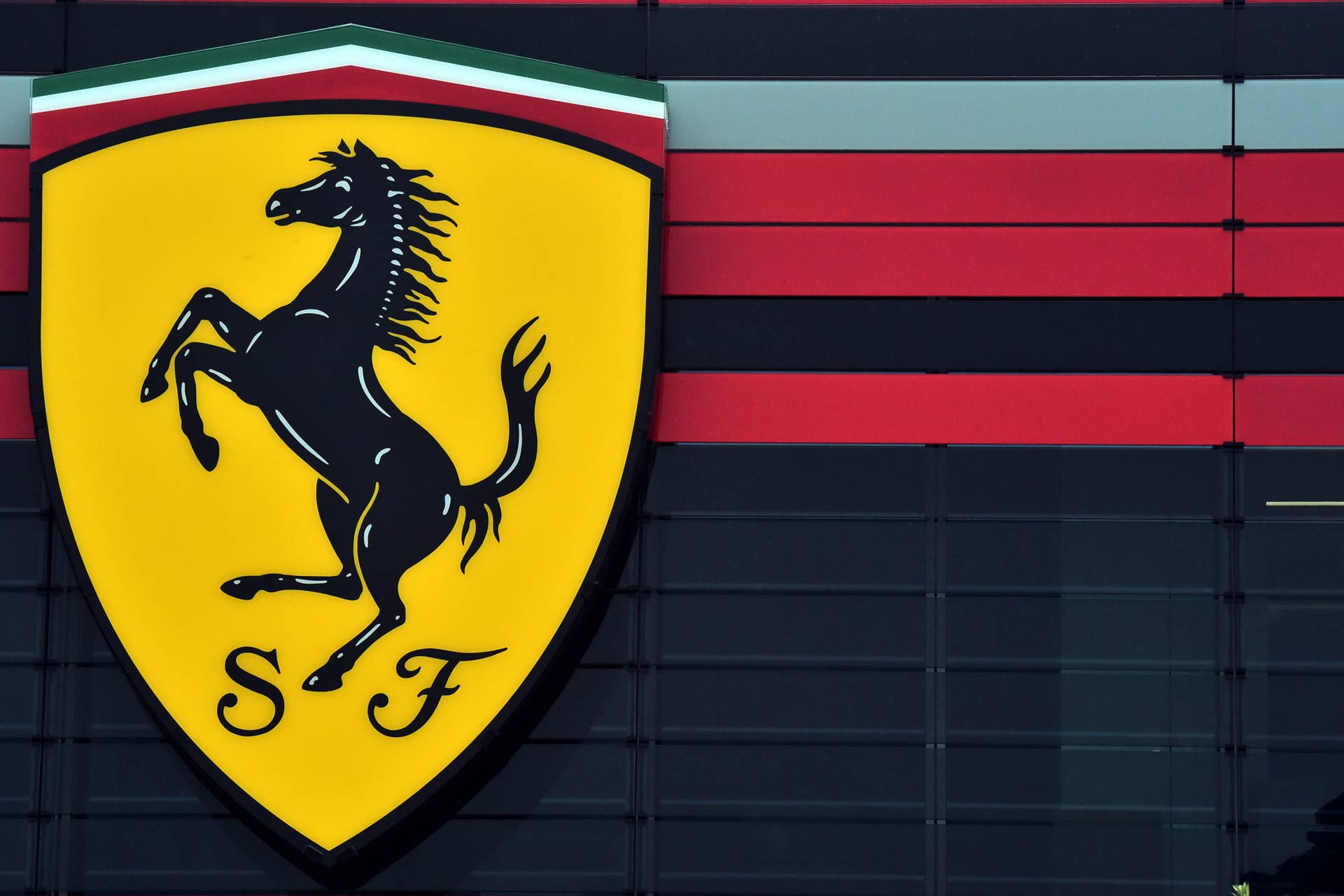 The famous logo of car maker Ferrari representing a prancing horse is pictured at the Ferrari factory on October 18, 2015 in Maranello. Fiat Chrysler Automobiles is planning a US stock debut for Ferrari that values the luxury Italian sports carmaker at nearly $10 billion, according to a filing with US regulators on October 10, 2015. Ferrari, of the famed 'prancing stallion' logo, will make its first steps on Wall Street, expected in late October, after years of rumors. AFP PHOTO / GIUSEPPE CACACE (Photo credit should read GIUSEPPE CACACE/AFP/Getty Images)