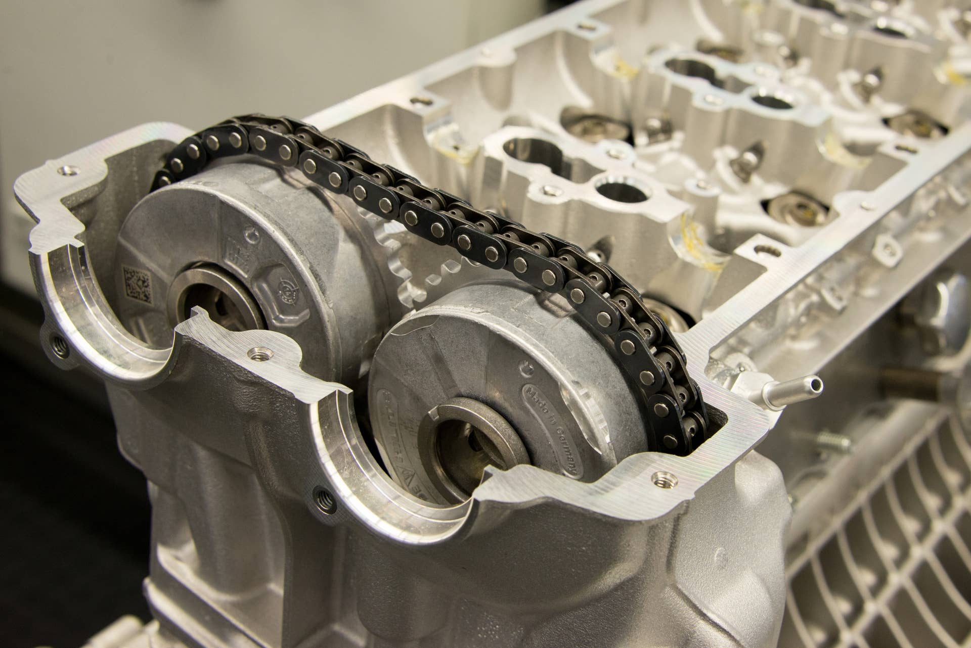 Seen in this image are the aluminum head, cam sprockets and timing chain of the 4.6-liter V8 during assembly. When finished, the dry-sump powerplant will develop 608 horsepower without any assistance from the electric motors.