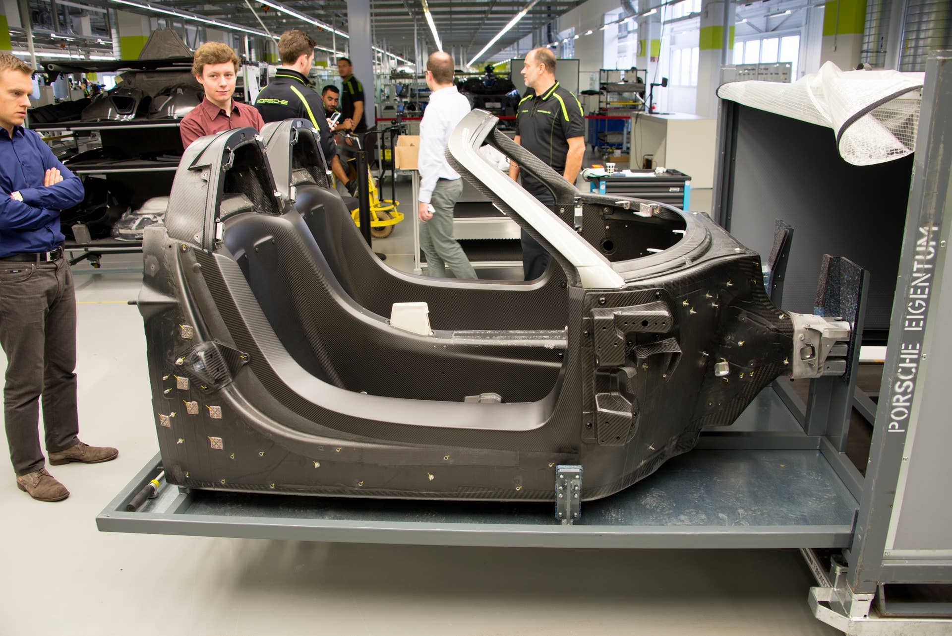 Delivered in a steel-framed container, the 918's tub — the building block for this vehicle's platform — is made from resin-injected carbon-fiber, manufactured by CarboTech in neighboring Austria (the company also builds tubs for McLaren). While all of the tubs arrive in a sturdy shipping box, this particular example is unique because the customer ordered a special matte finish on the door sills (they are exposed on the finished vehicle). The team is inspecting the unique craftsmanship before assembly begins.