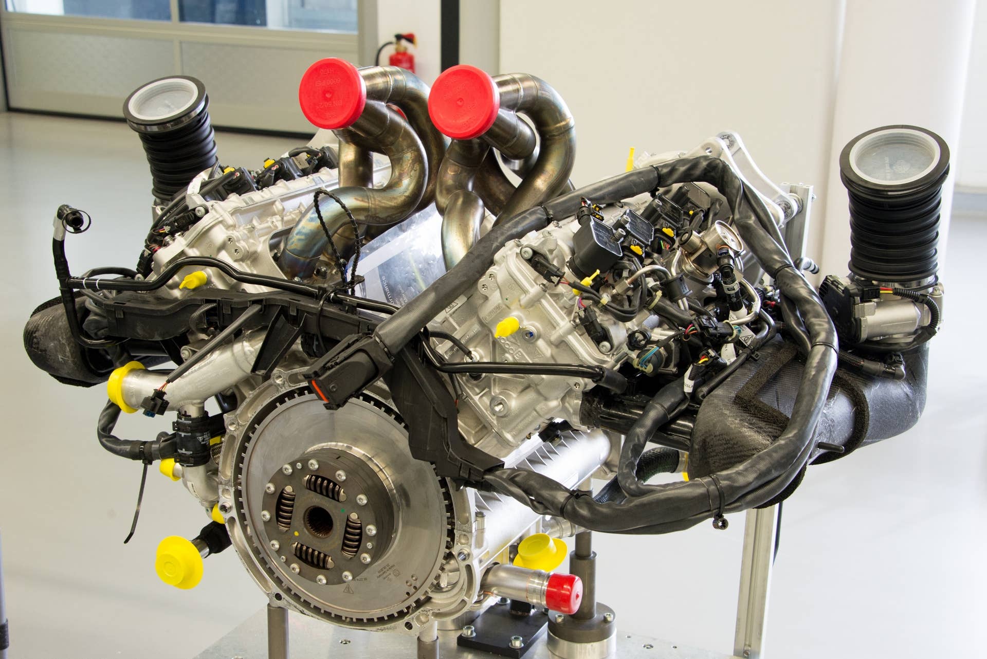 This is the best look you'll ever get of the 4.6-liter, race-bred V8 that powers the Porsche 918 — fully assembled and waiting for its turn on the dynamometer (plastic caps, in white, red and yellow, prevent debris from entering the engine).  The 90-degree V8, with titanium connecting rods and a redline of 9,150 rpm, will be nestled deep inside the chassis and all but buried from view when the vehicle is finished.