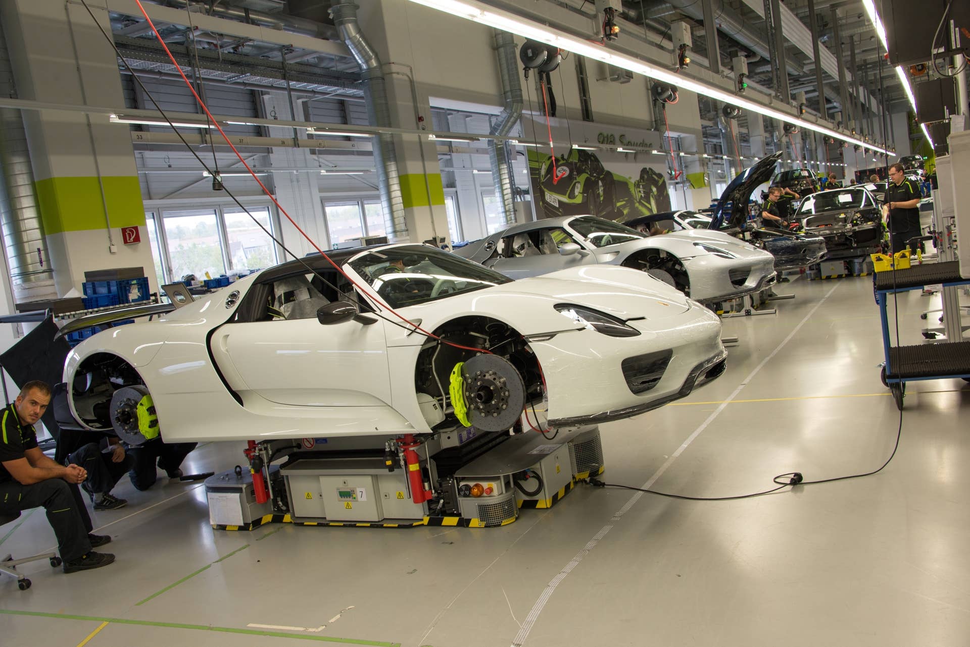 Near the end of the line, this Weissach Package 918 is awaiting its wheels. In addition to the hidden weight savings, the Weissach models are easily identified by their carbon-fiber aero fairings just aft of the rear wheels (to the right of the worker's head in this image).