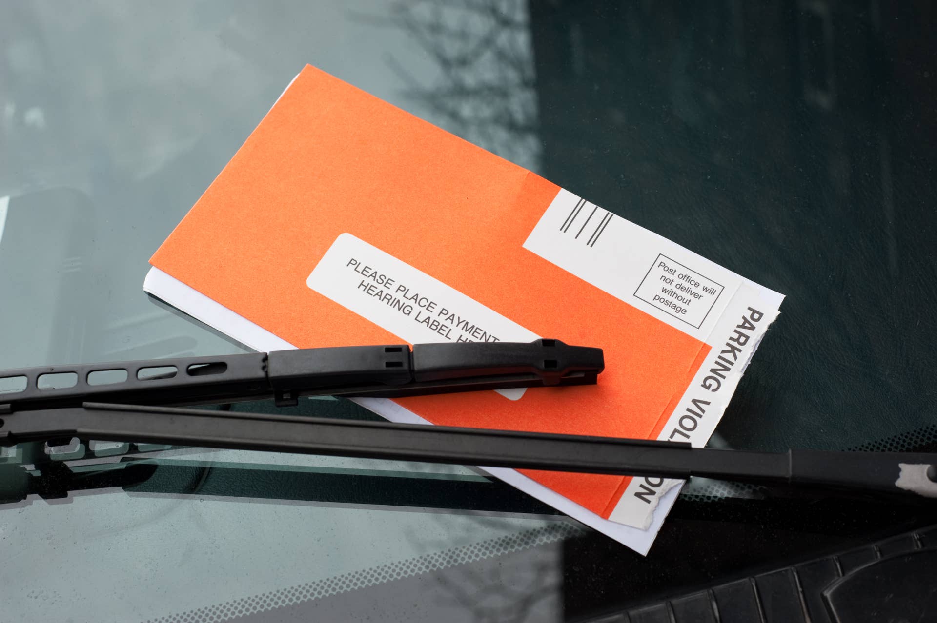 Parking ticket under the windshield wiper of a van