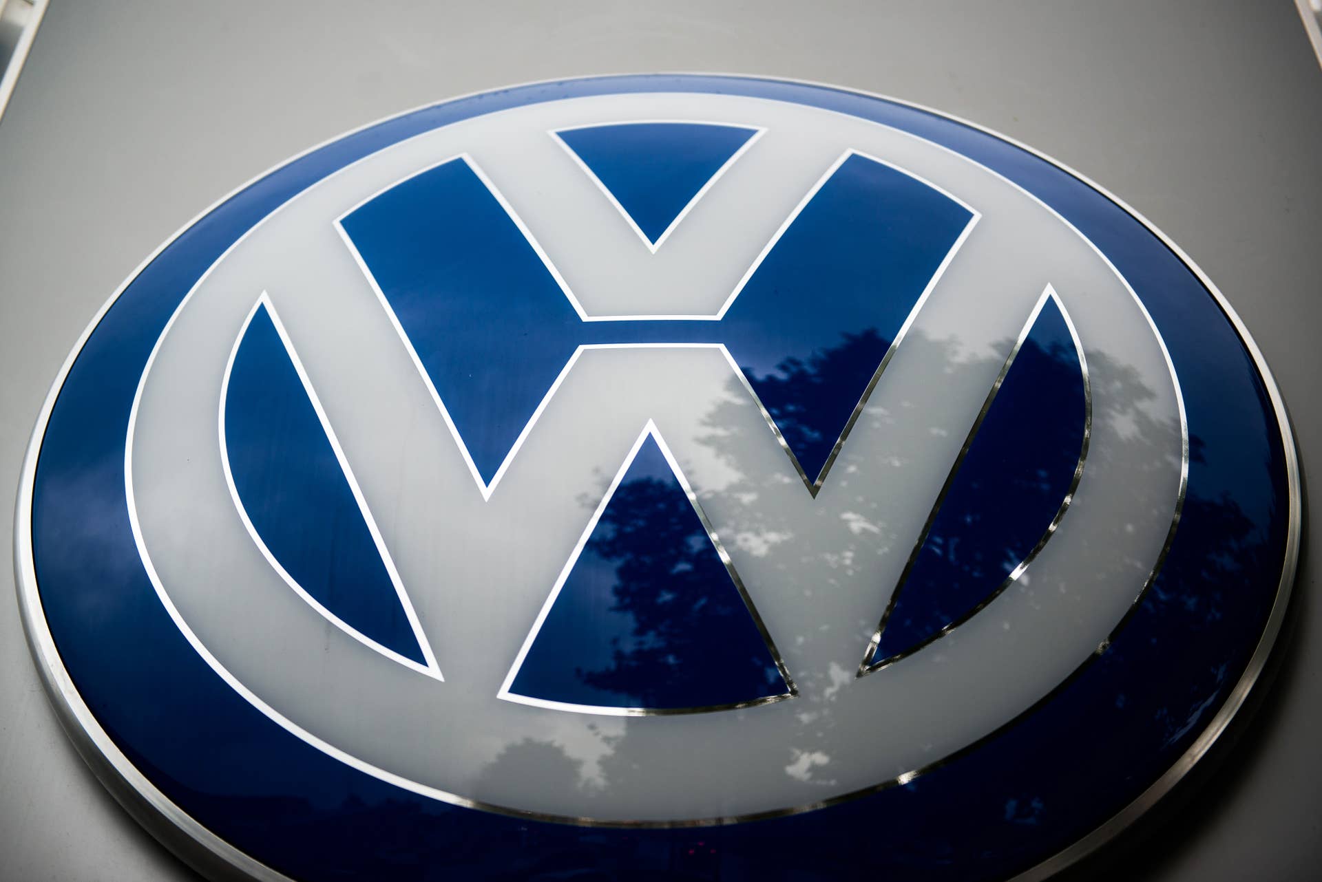 A Volkswagen AG badge sits on a sign outside an automobile dealership in Vienna, Austria, on Thursday, Oct. 8, 2015. Volkswagen AG will probably start recalling diesel cars with rigged emissions systems in January and plans to complete the repairs by the end of 2016. Photographer: Akos Stiller/Bloomberg via Getty Images