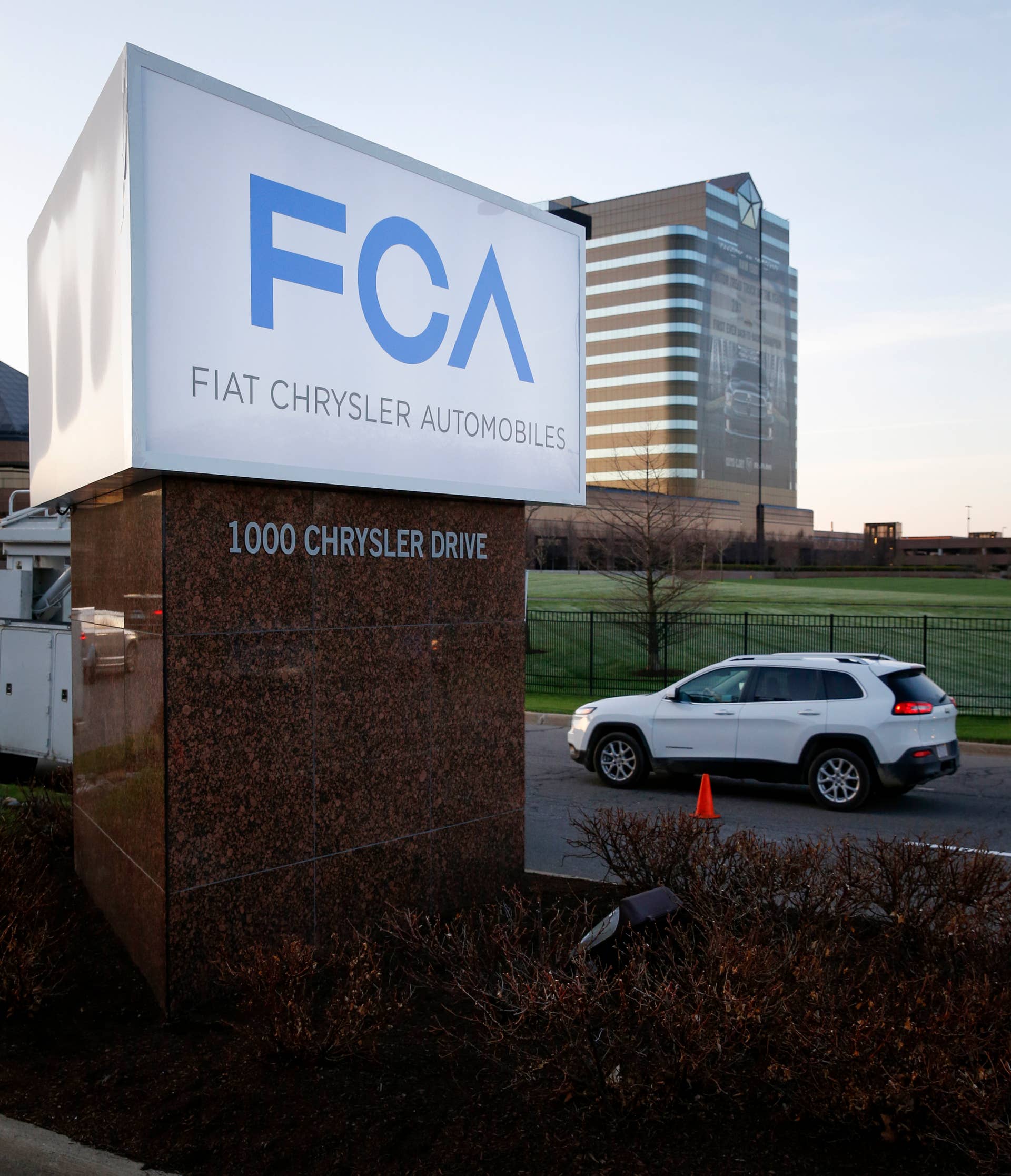The new FCA (Fiat Chrysler Automobile) logo is displayed in front of Chrysler Group LLC World Headquarters in Auburn Hills, Michigan, U.S., on Tuesday, May 6, 2014. Fiat SpA Chief Executive Officer Sergio Marchionne will cover the billions planned for new Alfa Romeos, Maseratis and Jeeps out of existing funds, without selling or spinning off any of the automaker's brands, four people familiar with the matter said. Photographer: Jeff Kowalsky/Bloomberg via Getty Images