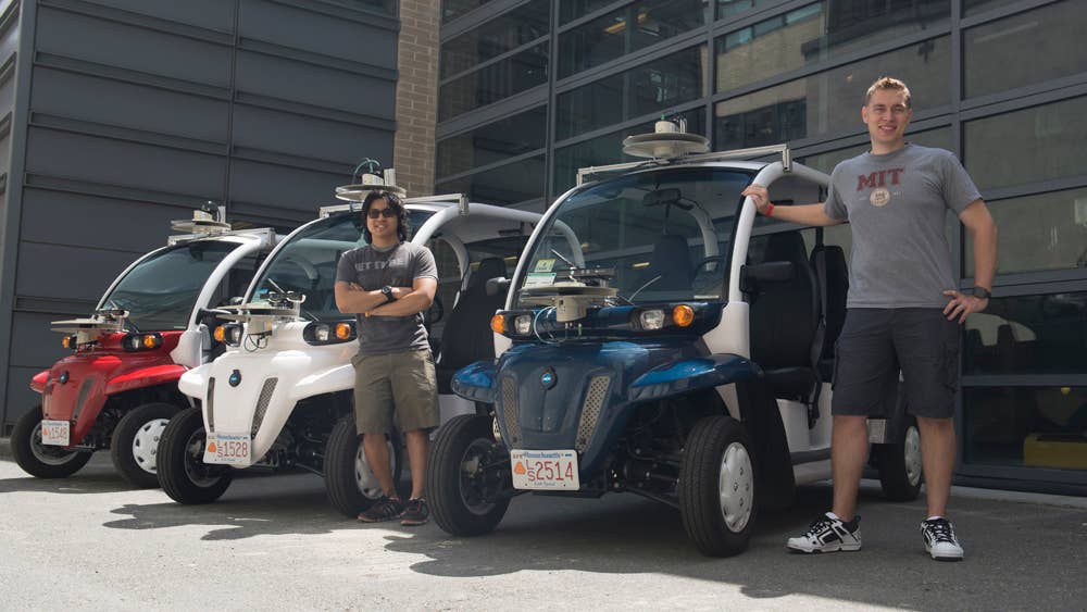 Graduate student Justin Miller and undergrad Wally Wibowo of the Aerospace Controls Lab working on vehicles outfitted with sensors that match those of self-driving cars. This work is part of the Ford-MIT Alliance and aims to predict pedestrian behaviors on short time-scales while also providing data to support a mobility-on-demand system for the MIT campus.