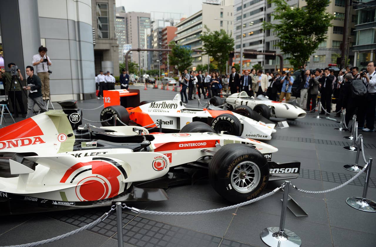 The three-generation Honda Formula One cars,  (front to rear) 2006 Honda RA106, 1988 McLaren Honda MP4/4 and 1965 Honda RA272, are on display in front of Honda headquarters after the press conference in Tokyo on May 16, 2013. Japanese automaker Honda said it will return to Formula One in 2015 as an engine supplier to British team McLaren in a bid to revive their championship-winning partnership.          AFP PHOTO / TOSHIFUMI KITAMURATOSHIFUMI KITAMURA/AFP/Getty Images