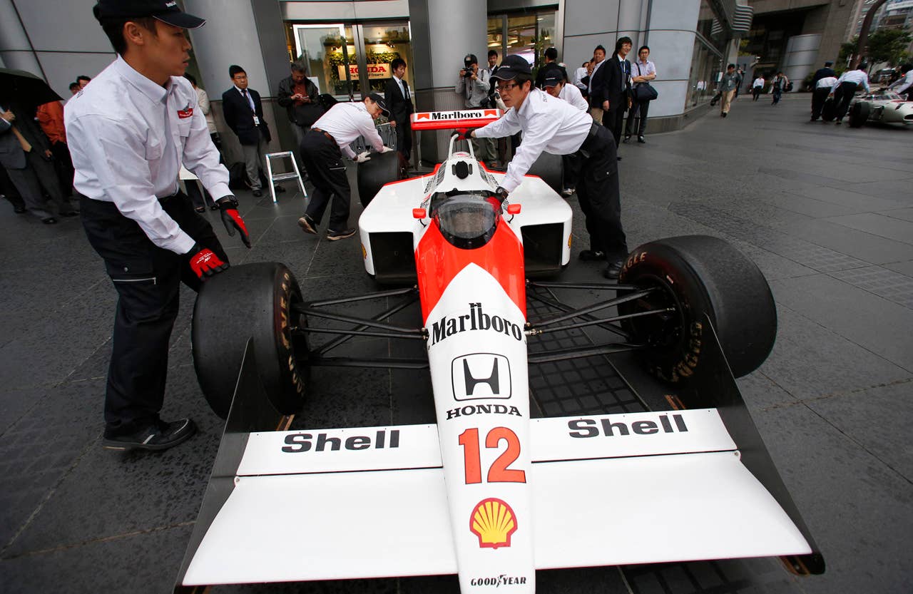McLaren Honda MP 4/4 car which was steered by the late Brazilian Formula One driver Ayrton Senna is removed after being displayed in front of the Honda Motor Co. headquarters in Tokyo Thursday, May 16, 2013. Japanese automaker Honda is returning to Formula One in 2015 as an engine supplier to McLaren, recreating a partnership that was dominant in the 1980s and 1990s. Honda President Takanobu Ito announced the decision at a news conference on Thursday, reversing the decision made in 2008 to pull out of the expensive sport due to the effects of the global financial crisis. (AP Photo/Shizuo Kambayashi)
