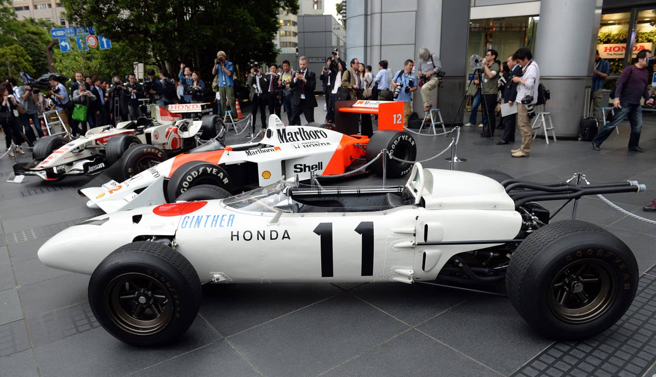The three-generation Honda Formula One cars,  (front to rear)1965 Honda RA272, 1988 McLaren Honda MP4/4 and 2006 Honda RA106, are on display in front of Honda headquarters after the press conference in Tokyo on May 16, 2013. Japanese automaker Honda said it will return to Formula One in 2015 as an engine supplier to British team McLaren in a bid to revive their championship-winning partnership.          AFP PHOTO / TOSHIFUMI KITAMURATOSHIFUMI KITAMURA/AFP/Getty Images