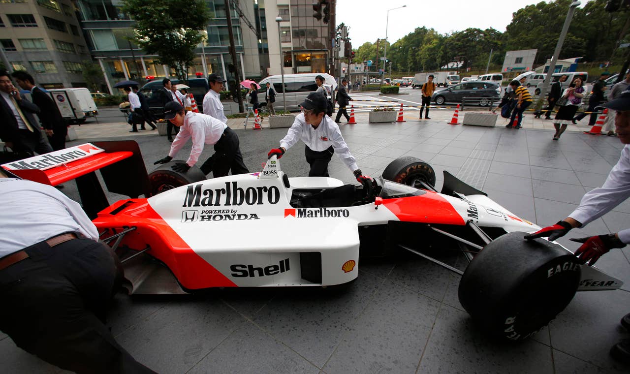 McLaren Honda MP 4/4 car which was steered by the late Brazilian Formula One driver Ayrton Senna is removed after being displayed in front of the Honda Motor Co. headquarters in Tokyo Thursday, May 16, 2013. Japanese automaker Honda is returning to Formula One in 2015 as an engine supplier to McLaren, recreating a partnership that was dominant in the 1980s and 1990s. Honda President Takanobu Ito announced the decision at a news conference on Thursday, reversing the decision made in 2008 to pull out of the expensive sport due to the effects of the global financial crisis. (AP Photo/Shizuo Kambayashi)