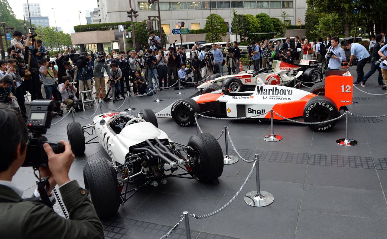 The three-generation Honda Formula One cars, 1965 Honda RA272 (L), 1988 McLaren Honda MP4/4 (C) and 2006 Honda RA106 (R), are on display in front of Honda headquarters after the press conference in Tokyo on May 16, 2013. Japanese automaker Honda said it will return to Formula One in 2015 as an engine supplier to British team McLaren in a bid to revive their championship-winning partnership.          AFP PHOTO / TOSHIFUMI KITAMURATOSHIFUMI KITAMURA/AFP/Getty Images