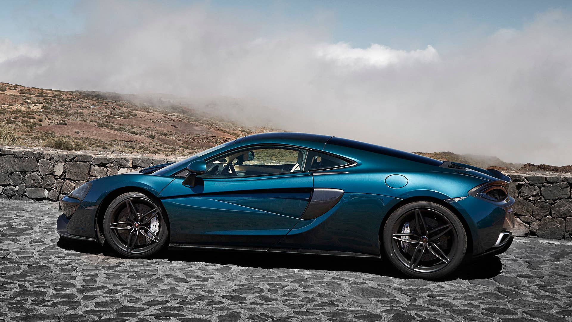 2017 McLaren 570GT rear 3/4 view