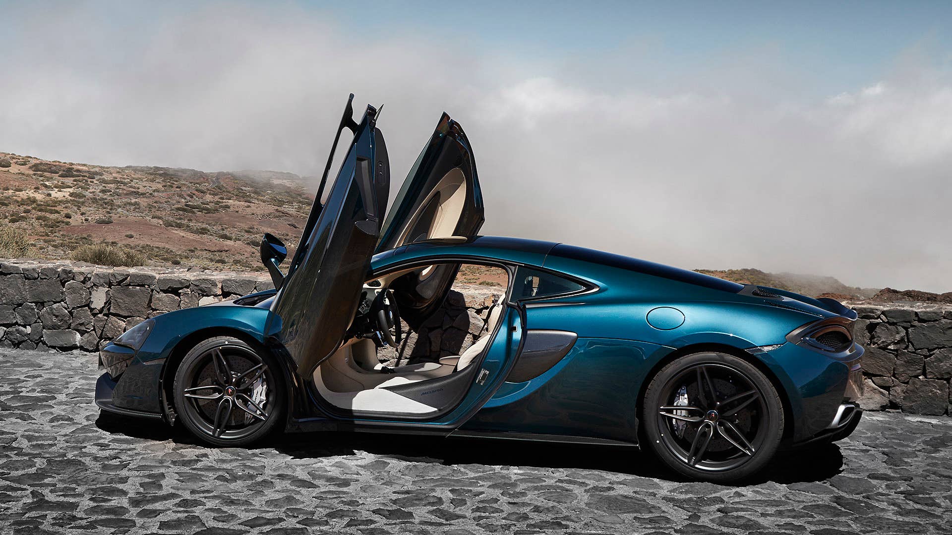 2017 McLaren 570GT rear 3/4 view