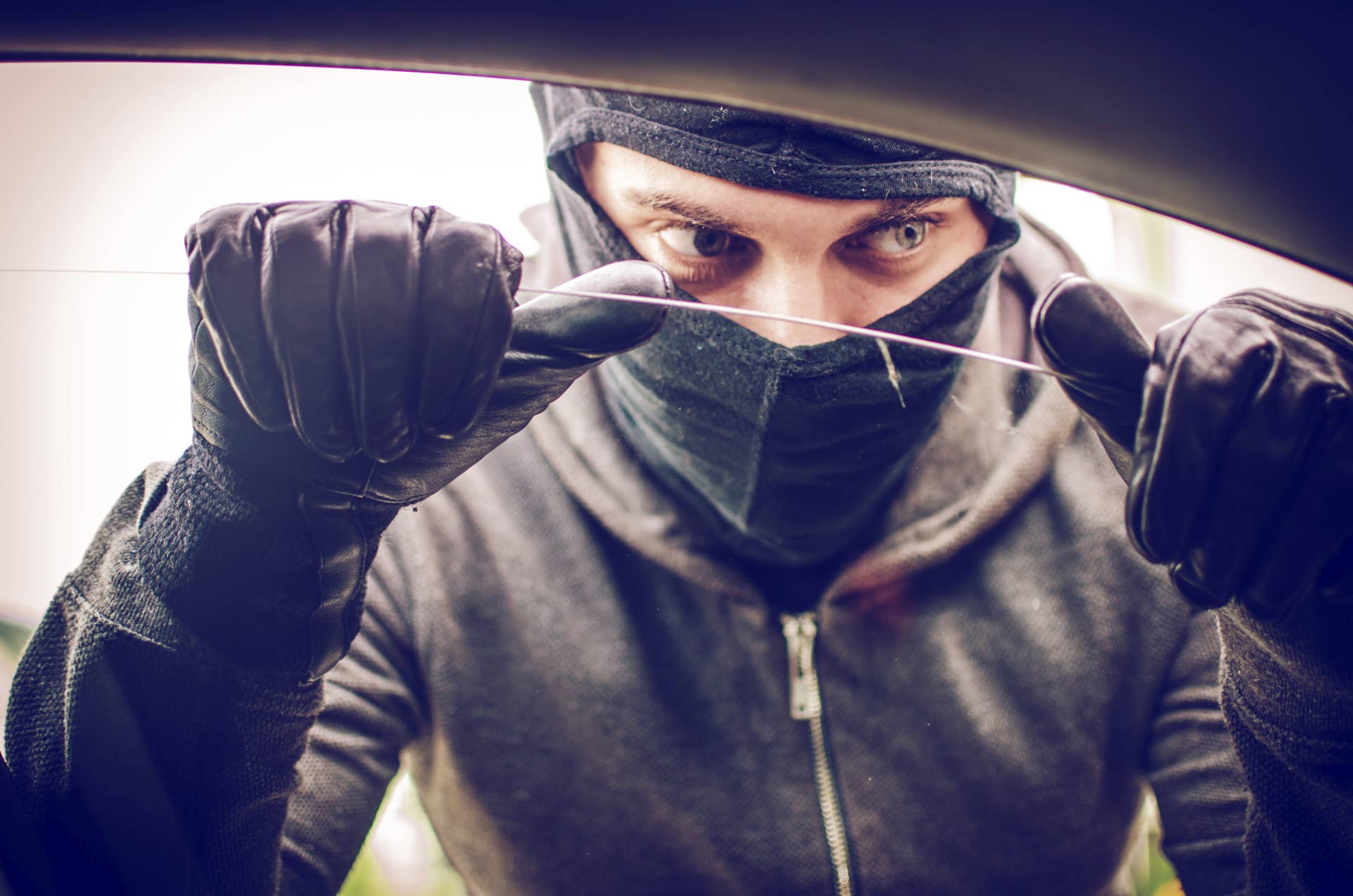 Car thief looking through the open window