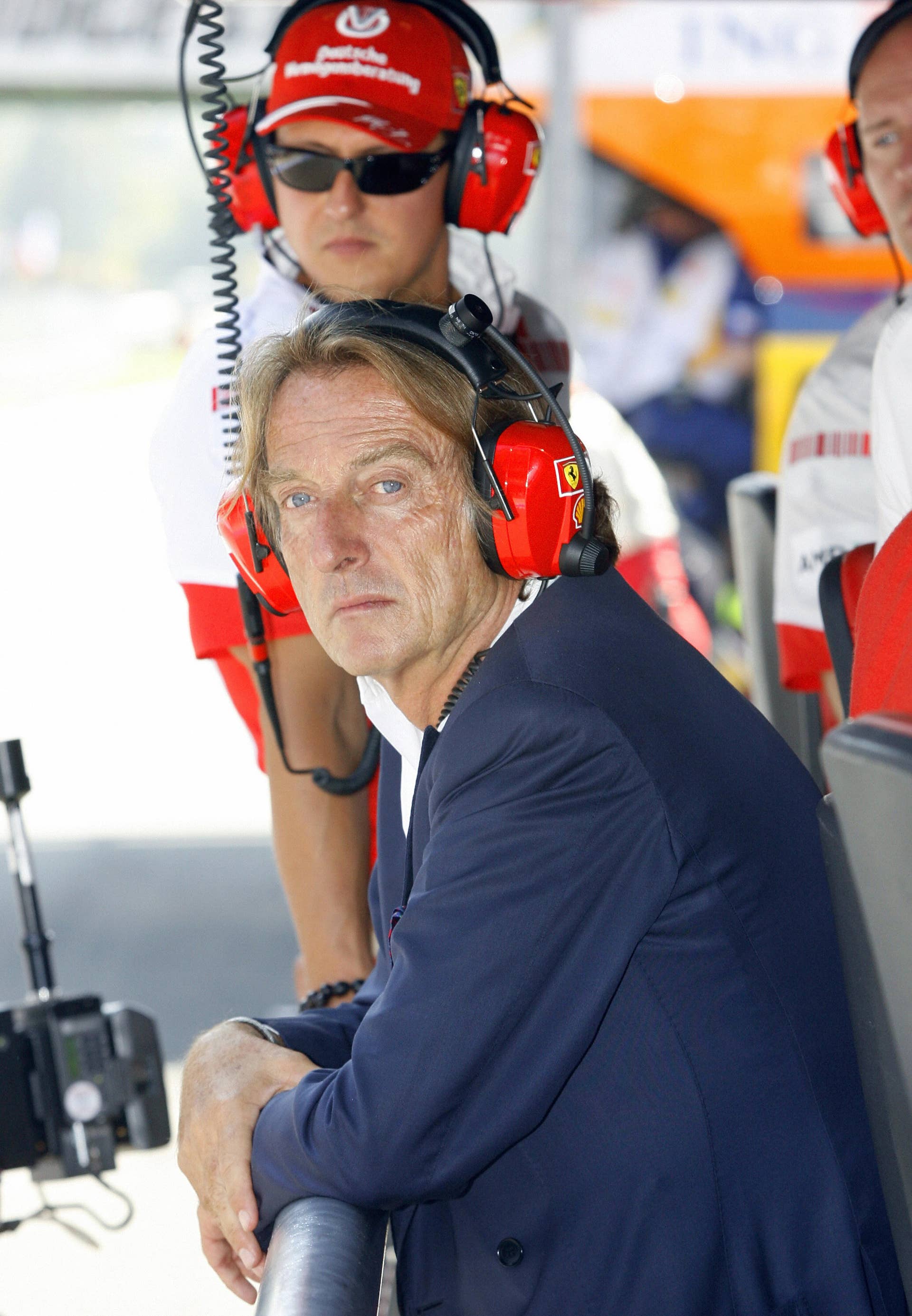 Former Ferrari driver German Michael Schumacher (back) and Ferrari president Luca di Montezemolo sit at a telemetry booth in the pits of the Monza racetrack, 08 September 2007 in Monza, during the qualifying session of the Italian Formula One Grand Prix. Spanish McLaren-Mercedes driver Fernando Alonso took the pole position ahead of British McLaren-Mercedes driver Lewis Hamilton and Brazilian Ferrari driver Felipe Massa. AFP PHOTO POOL GIAMPIERO SPOSITO (Photo credit should read GIAMPIERO SPOSITO/AFP/Getty Images)