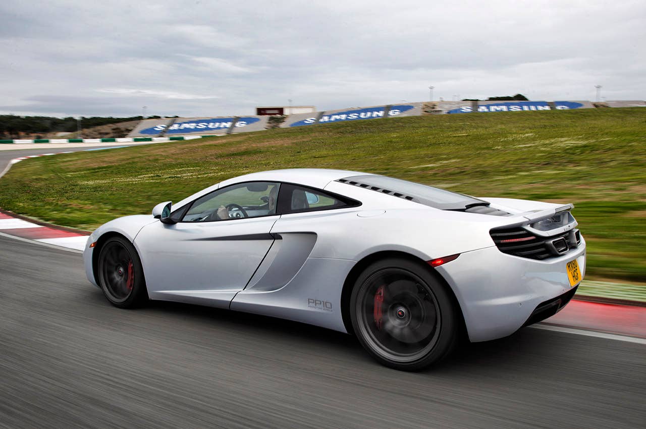 2012 McLaren MP4-12C rear 3/4 driving view
