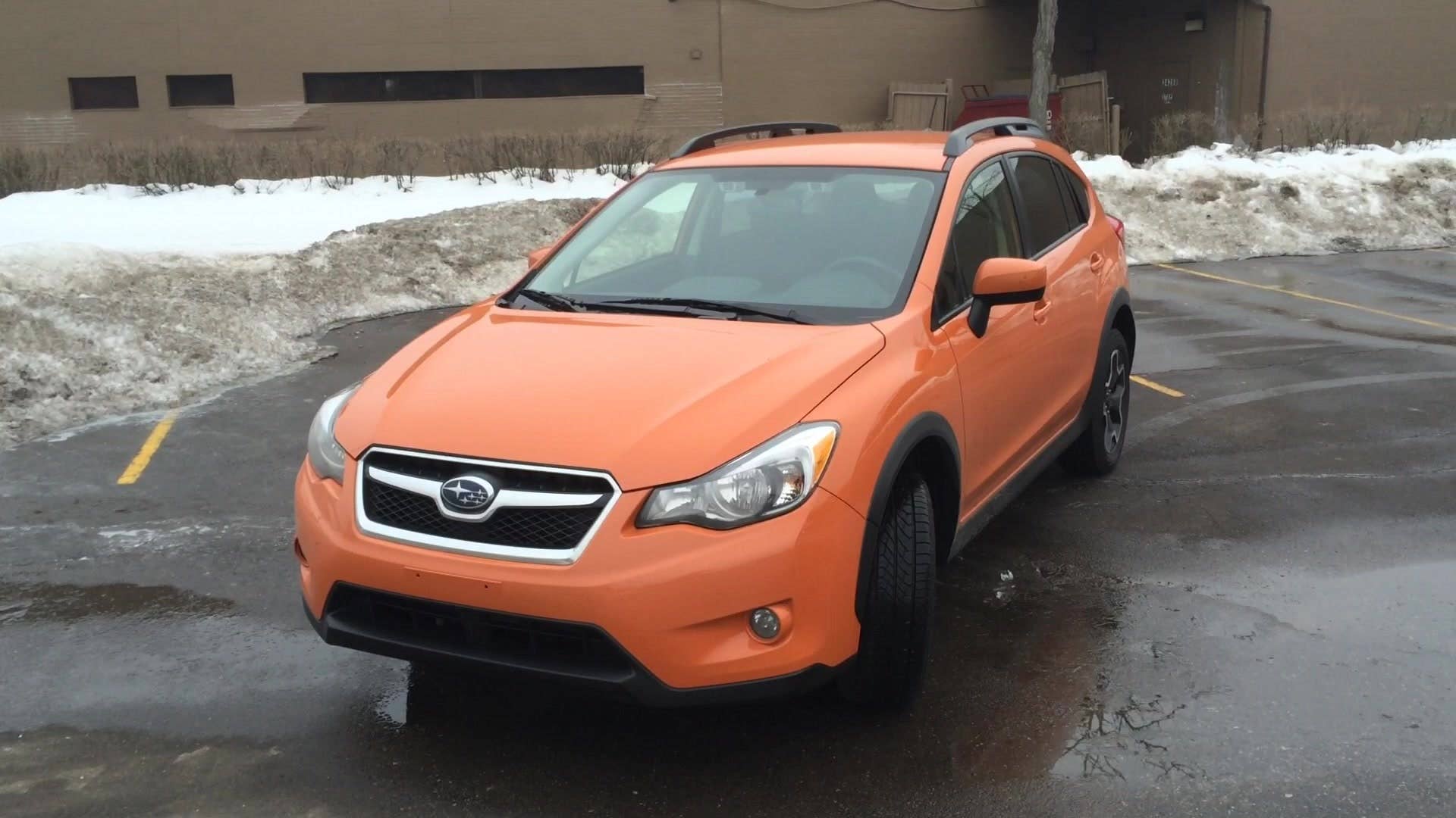 A 360-degree spin of the 2015 Subaru XV Crosstrek 2.0i Premium with tangerine orange pearl paint.
