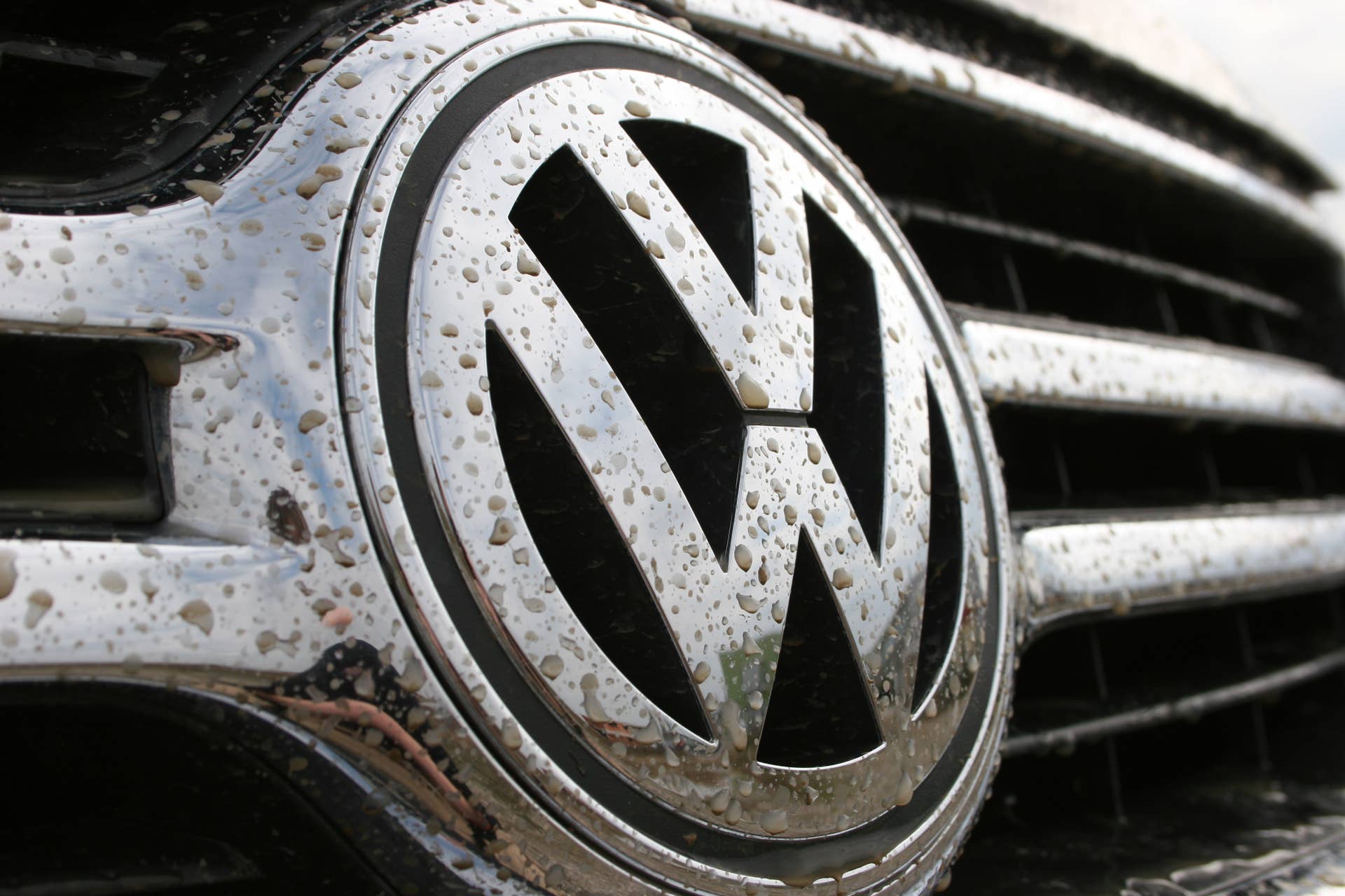'Zagreb, Croatia - March 15, 2008: Chrome premium Volkswagen sign covered in mud and water after driving through muddy terrain.'