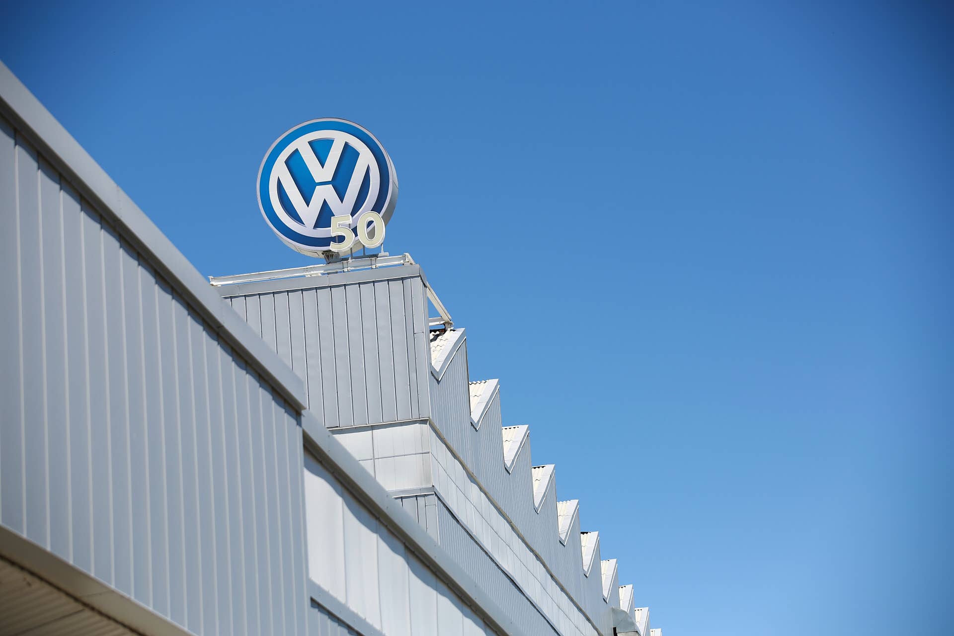 Volkswagen signage is displayed outside of the company's new production plant in Puebla, Mexico, on Thursday, Oct. 13, 2016. Volkswagen supervisory board member Stephan Weil stated that it is looking to increase car production significantly next year to levels last seen before the diesel scandal broke, with further gains probable in 2018. Photographer: Susana Gonzalez/Bloomberg via Getty Images